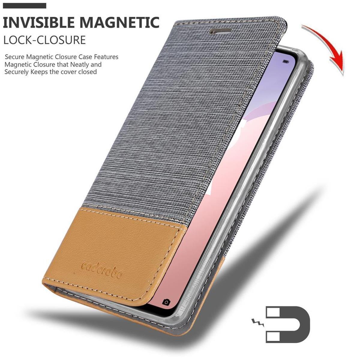Custodia del telefono aperta, che mostra lo schermo. La custodia è grigia con fondo in pelle marrone. Chiusura magnetica.