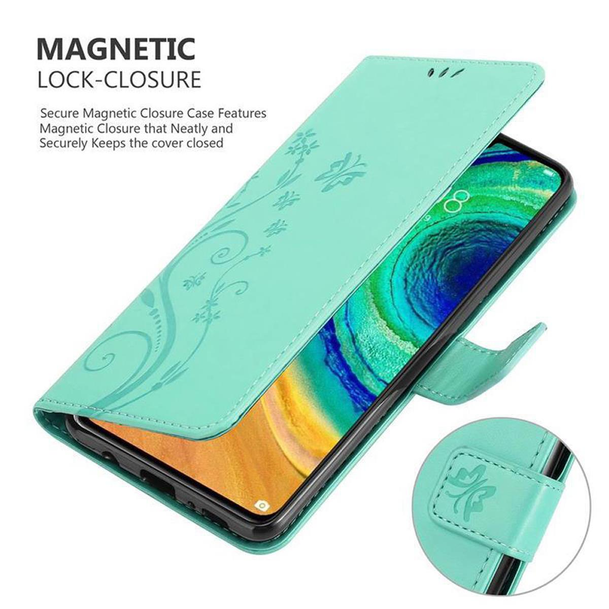 Un telefono in una custodia verde menta. La custodia ha una chiusura magnetica e un design floreale. Il telefono è in mostra.