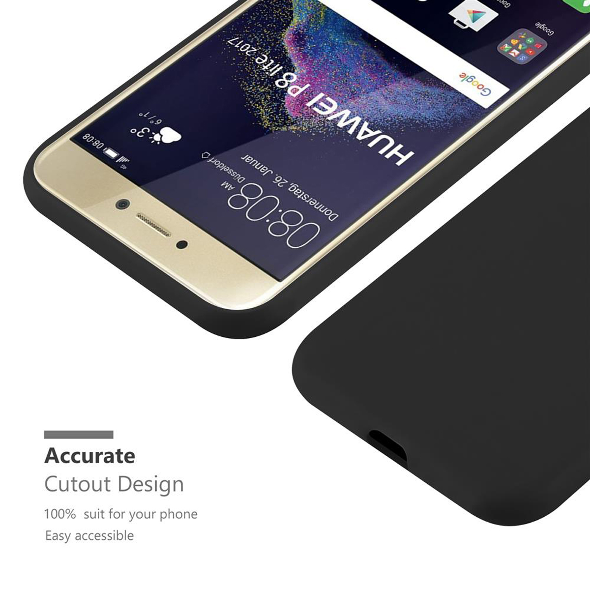 Teléfono dorado con funda negra, la pantalla muestra fecha y hora. Parte de una funda negra está al lado.
