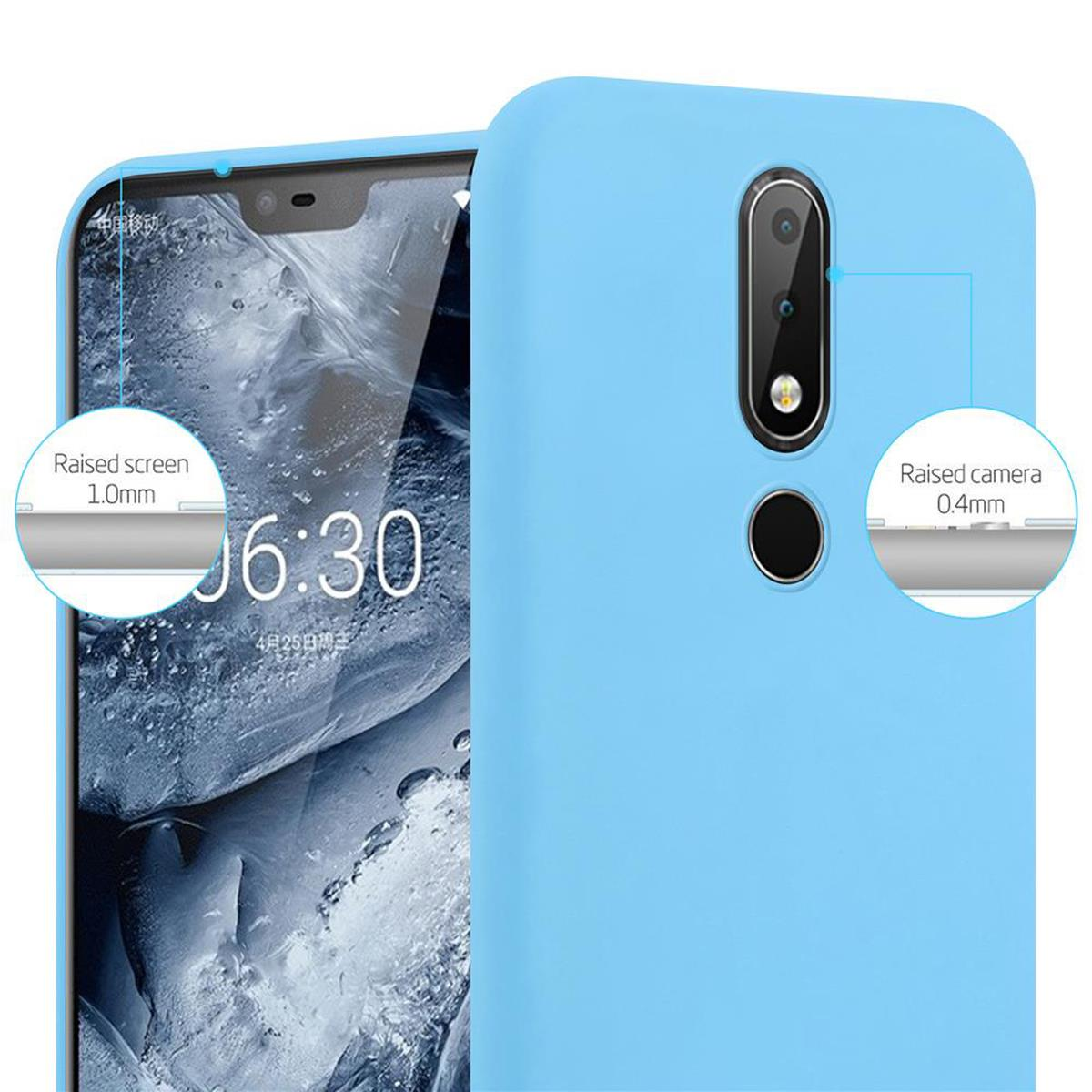 Un teléfono en una funda azul. El texto muestra detalles de la pantalla y la cámara elevadas. Son las 6:30.