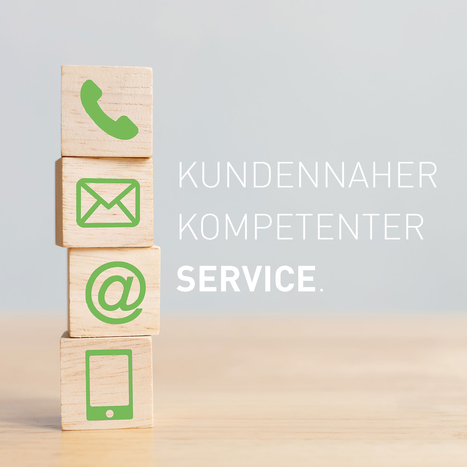 Vier Holzblöcke gestapelt mit grünen Symbolen: Telefon, Umschlag, E-Mail und Handy.