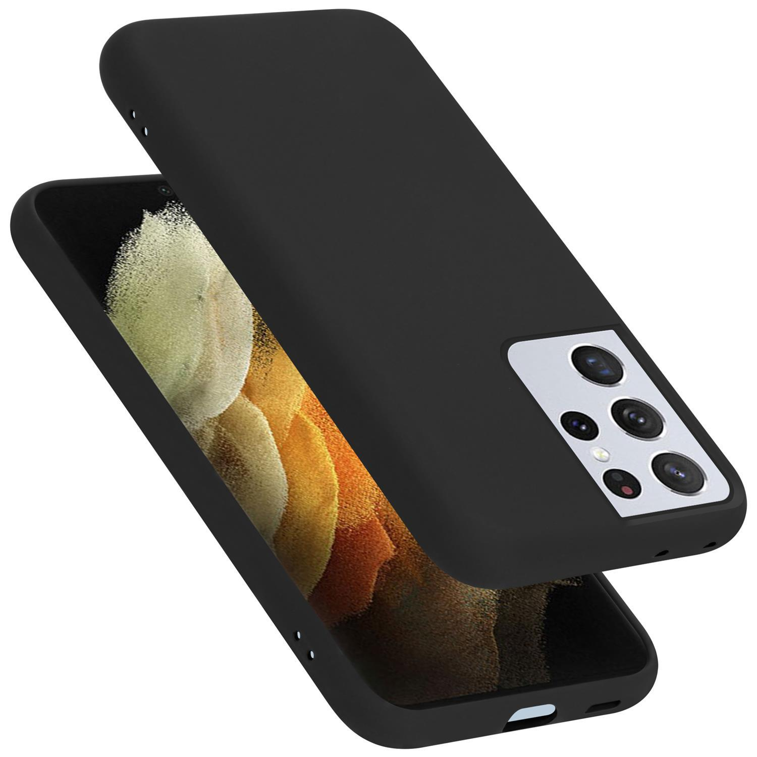 Eine schwarze Handyhülle mit einem schwarzen Telefon darin. Die Handyhülle befindet sich über dem Telefon.
