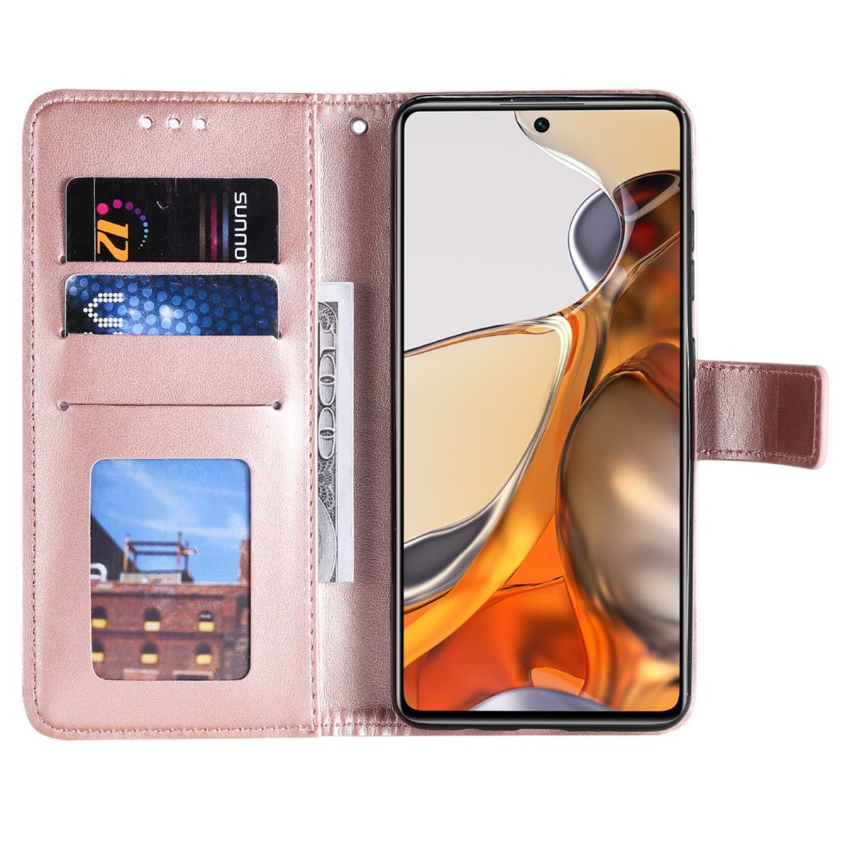 Geöffnete rosa Handyhülle mit Karten und einem Geldschein. Der Telefonbildschirm zeigt ein Gebäude.