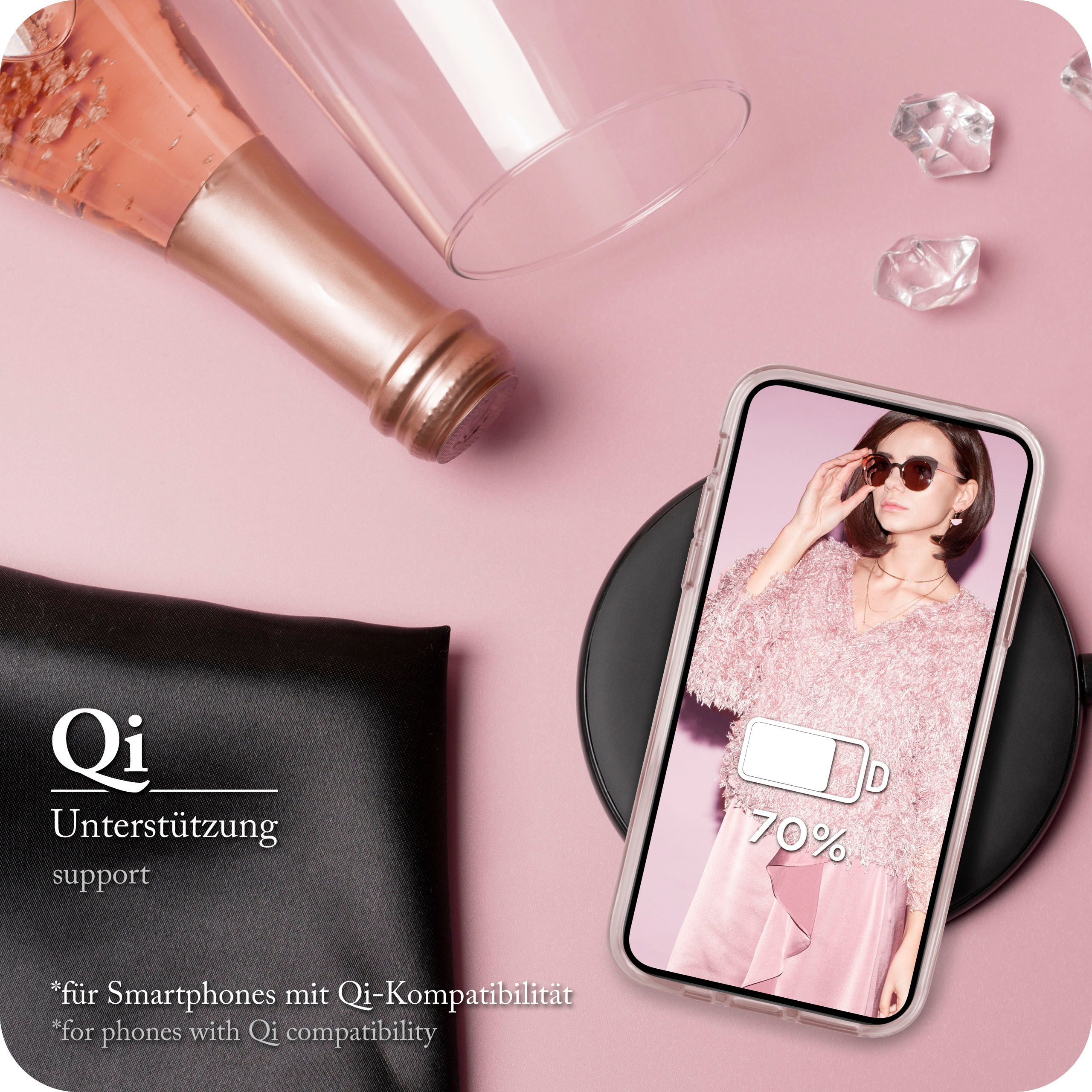 Ein Telefon in einer Hülle liegt auf einem kabellosen Ladegerät. Champagner, Glas und Frau sind da.