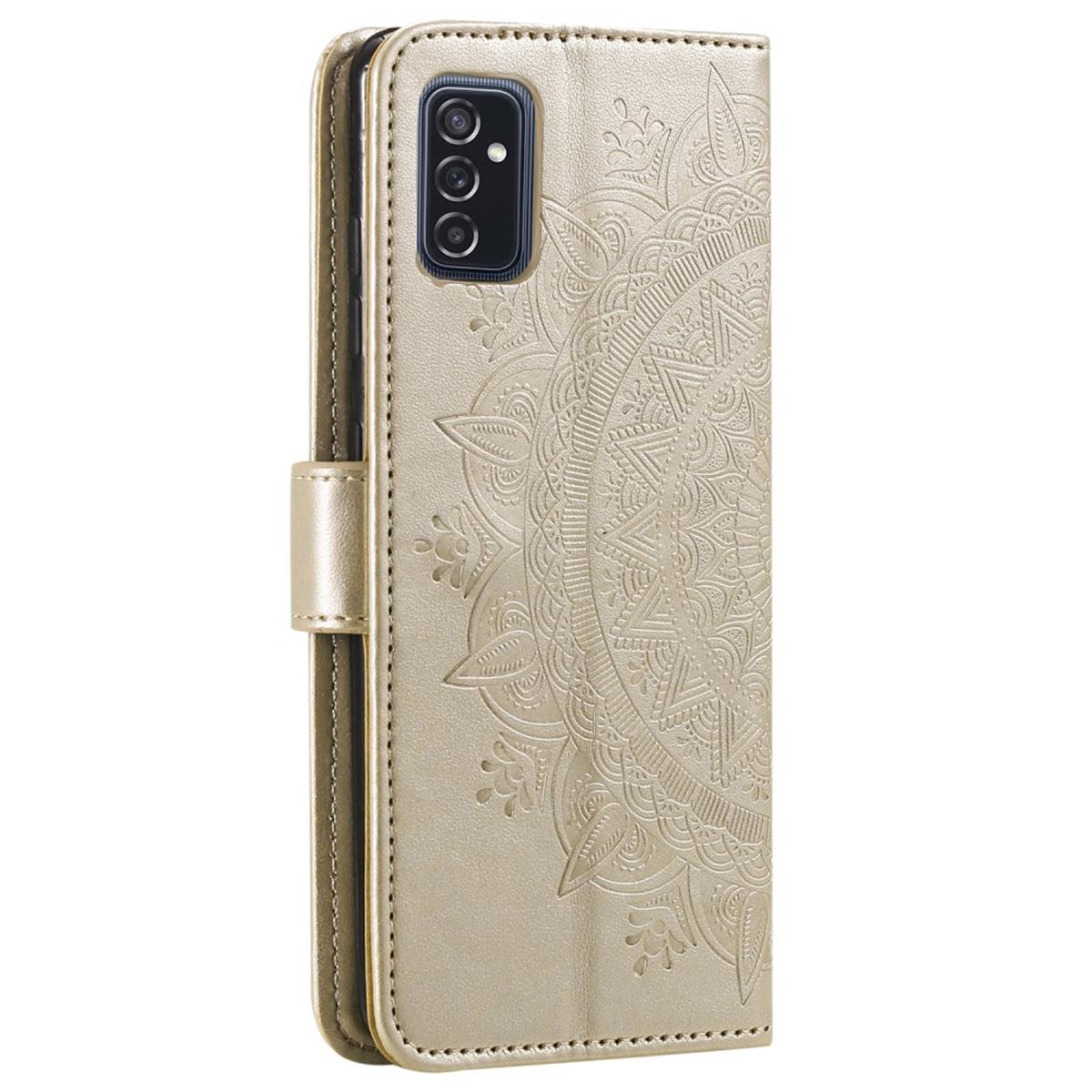 Goldene Handyhülle offen mit Mandala-Design. Schwarzes Telefon sichtbar. Weißer Hintergrund.