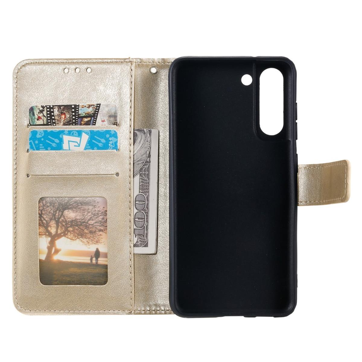 Goldene Handyhülle geöffnet, Karten, Geld und Telefon zeigend. Goldenes Leder.