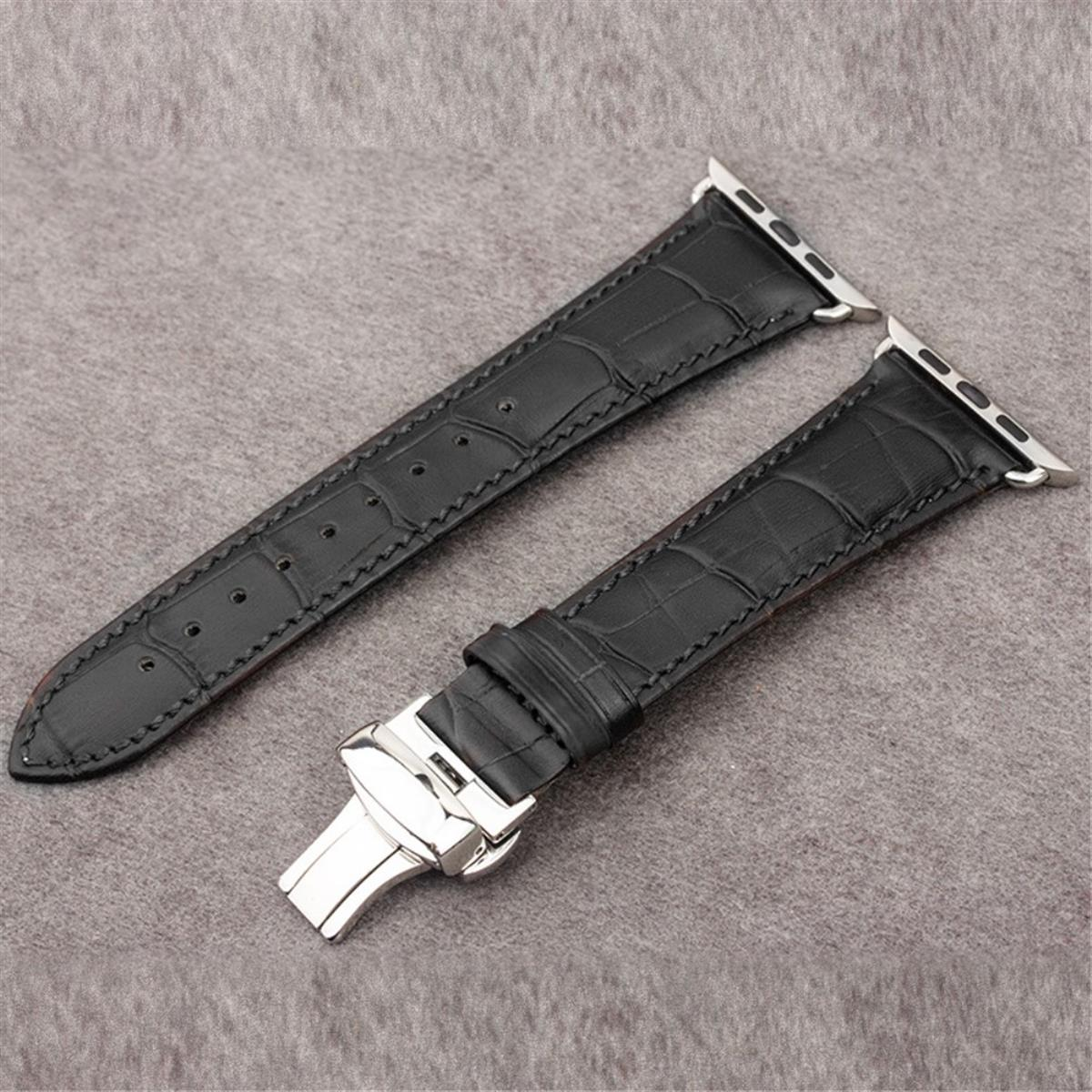 Zwei schwarze Leder-Uhrenarmbänder mit silberner Schnalle, auf grauer Oberfläche.