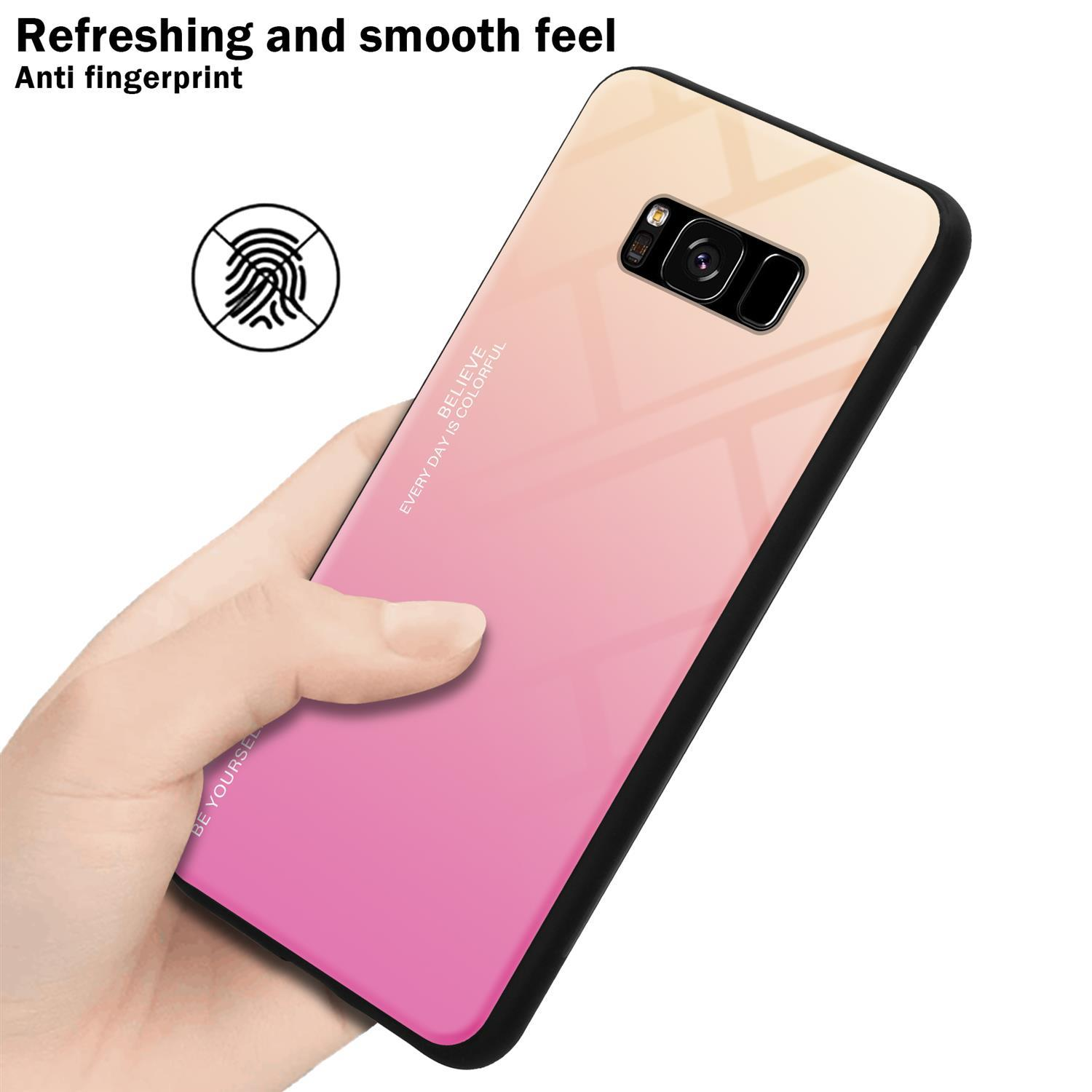 Mano che tiene un telefono con custodia rosa-gialla sfumata. Testo: Sensazione liscia.