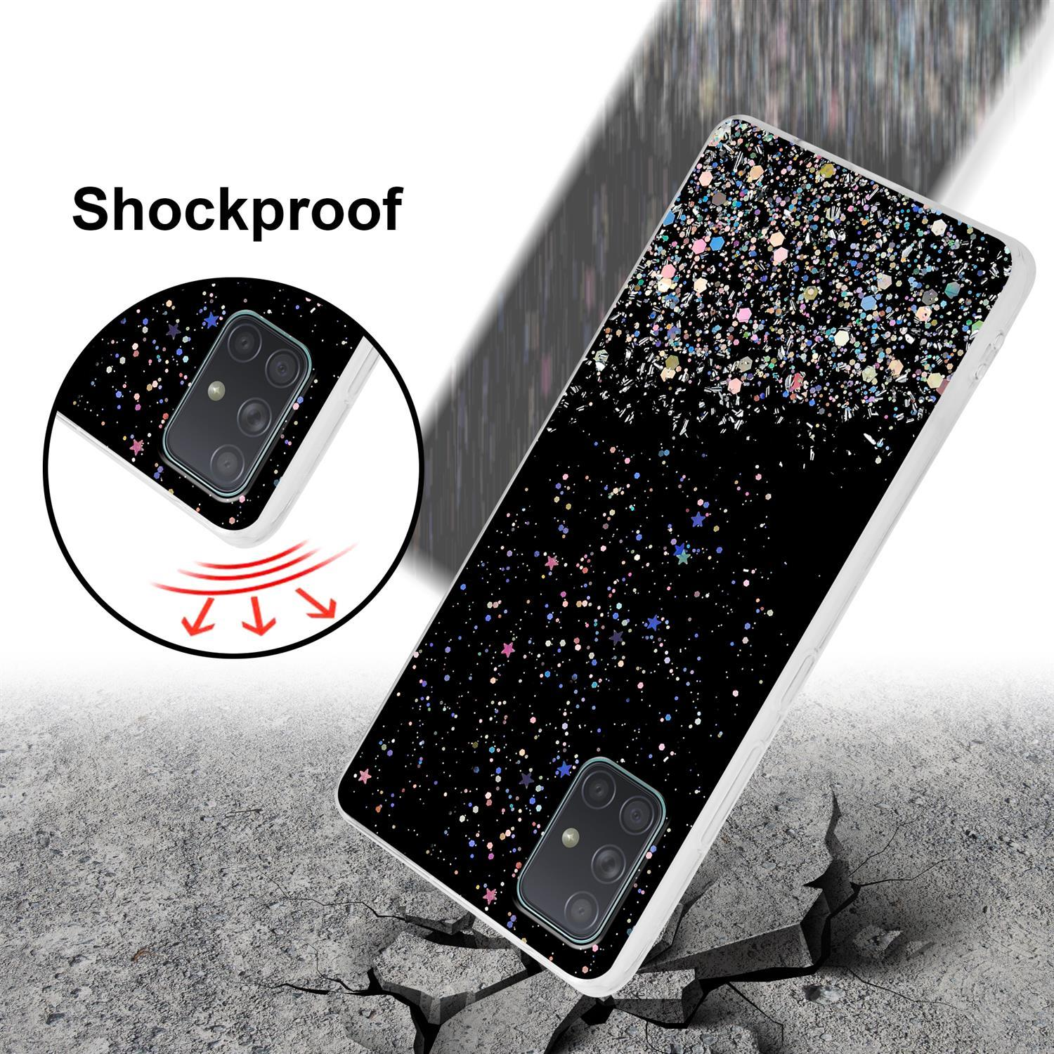 Handyhülle auf zerbrochenem Boden. Text: Stoßfest. Hülle hat schwarzen Hintergrund mit farbenfrohem Glitzerdesign.