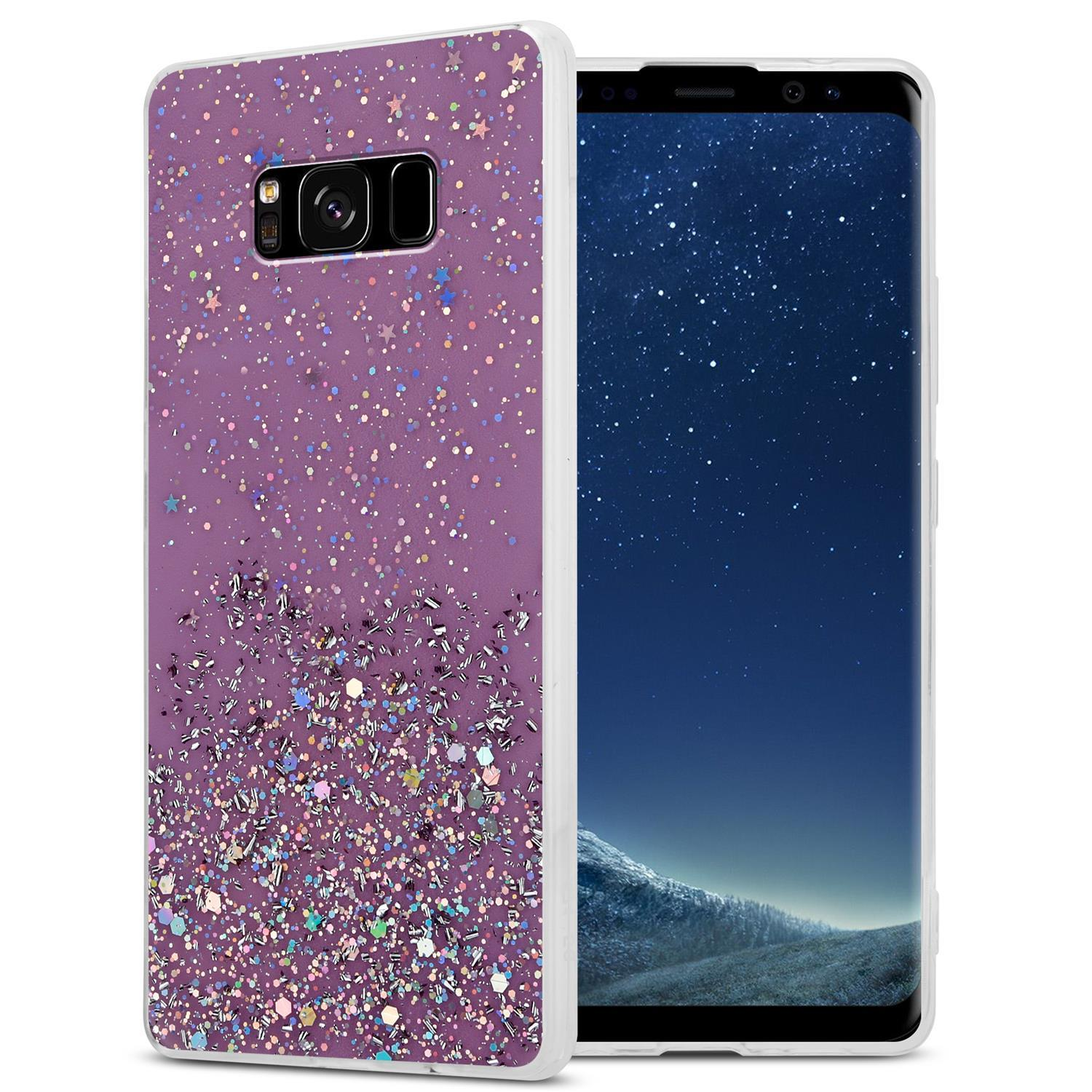 Telefon mit lila Glitzerhülle, das Telefon zeigt ein Nachthimmelbild.