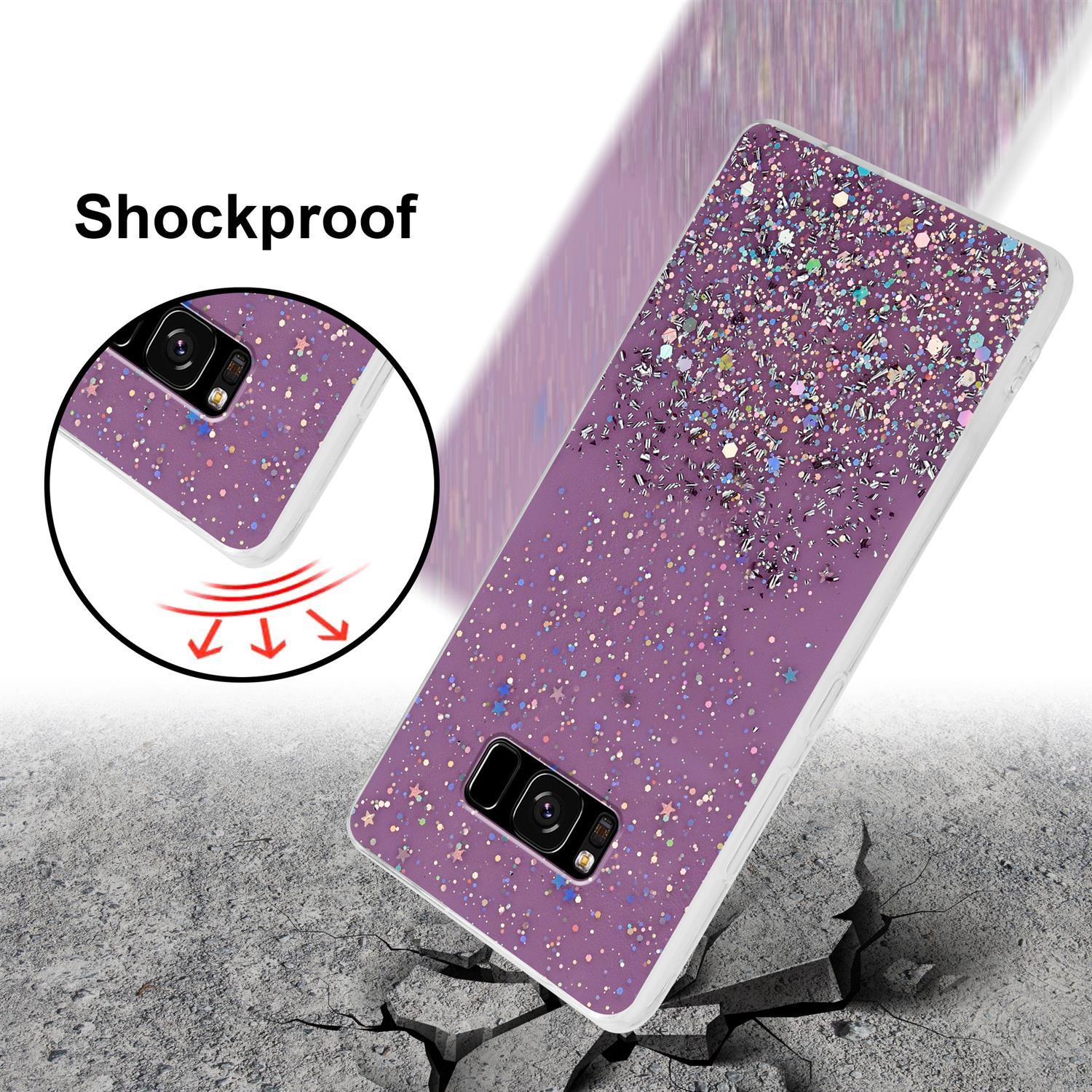 Lila Handyhülle mit Glitzereffekt auf einer rissigen Oberfläche, mit einem Telefon in der Hülle.