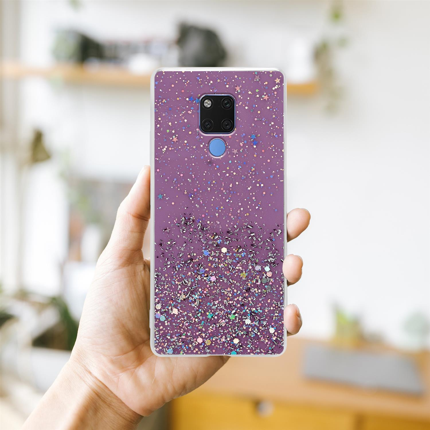 Handy-Hülle in der Hand, mit Glitzer-Design auf lila Hintergrund.