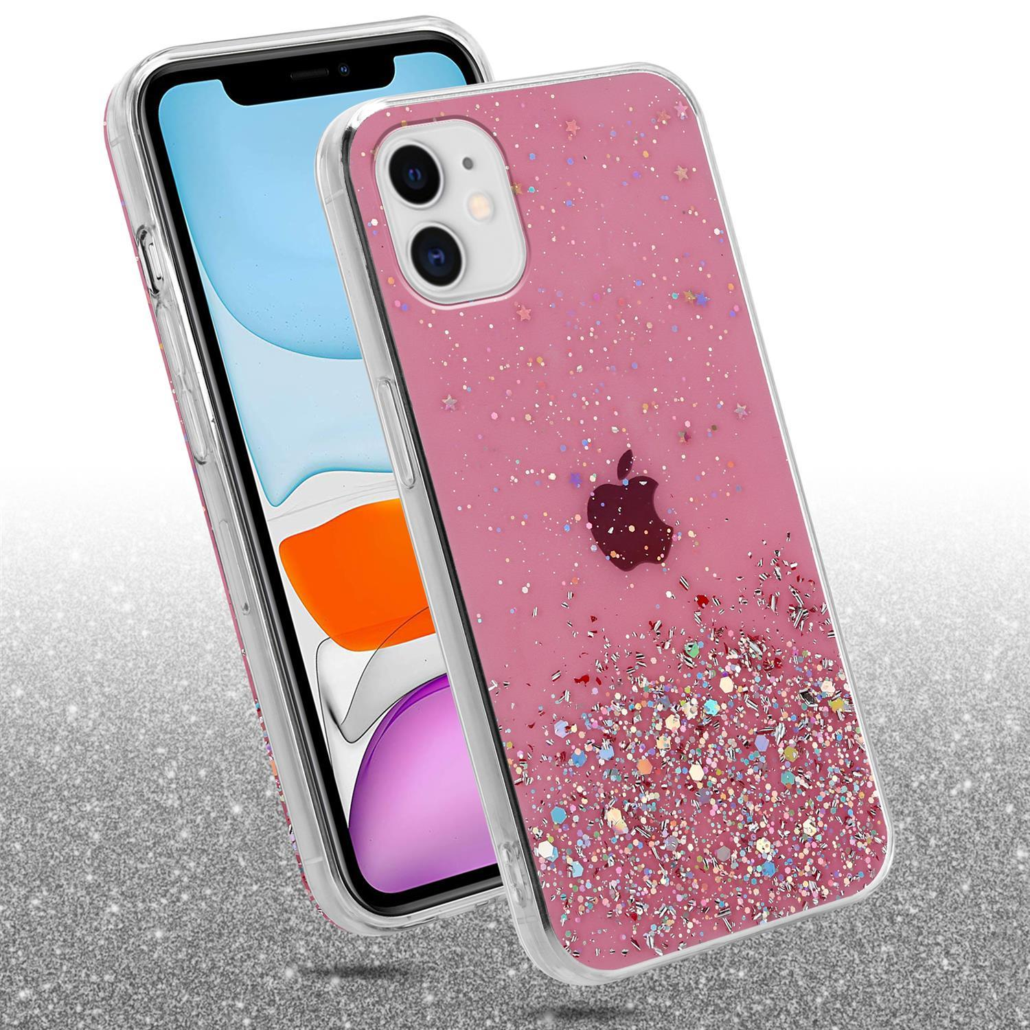 Rosa Glitzer-Handyhülle mit Telefon, das auf glitzernder Oberfläche liegt. Das Telefon hat ein schwarzes Apple-Logo.