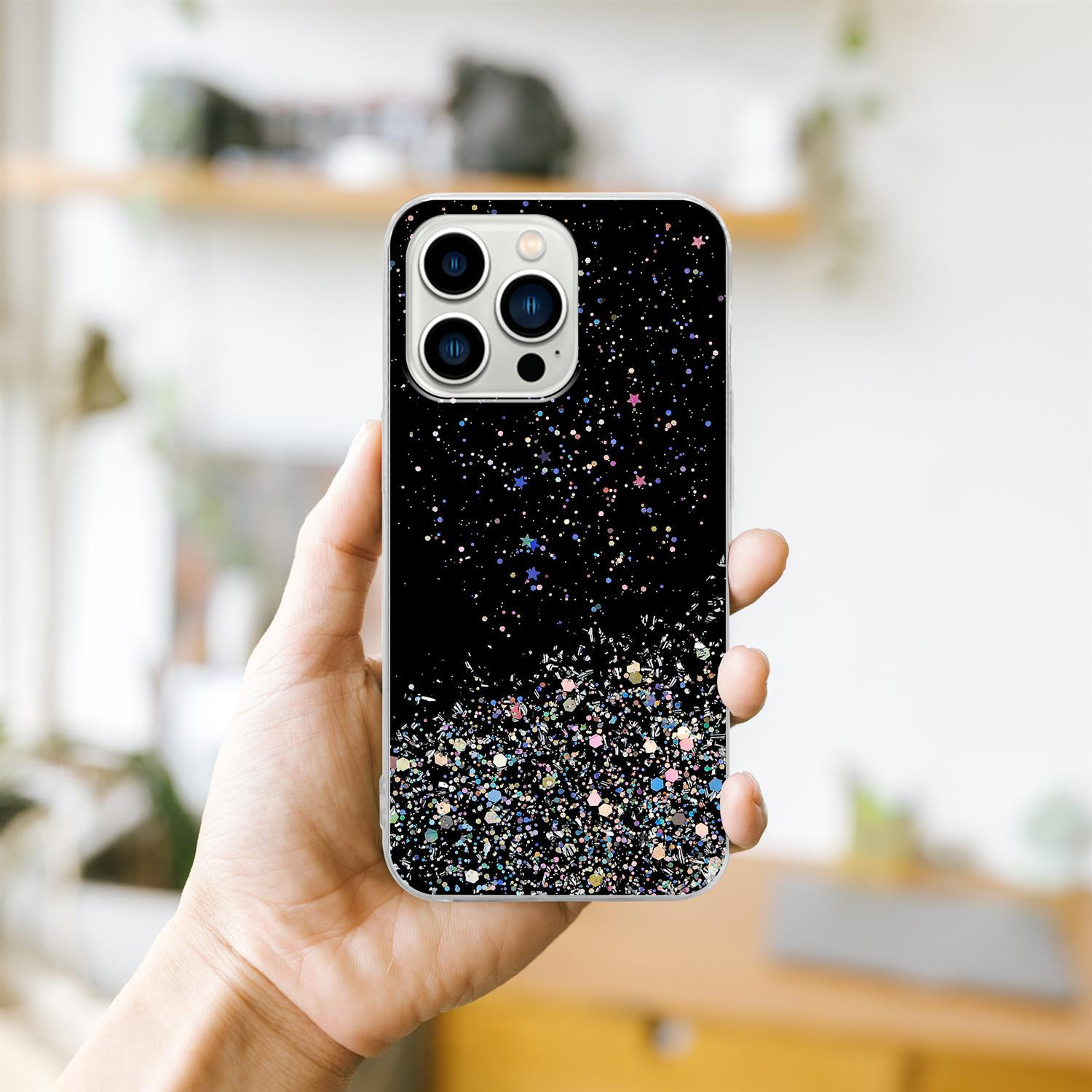 Hand hält eine schwarze Handyhülle mit Glitzer. Ein weißer Hintergrund mit einem Regal ist sichtbar.