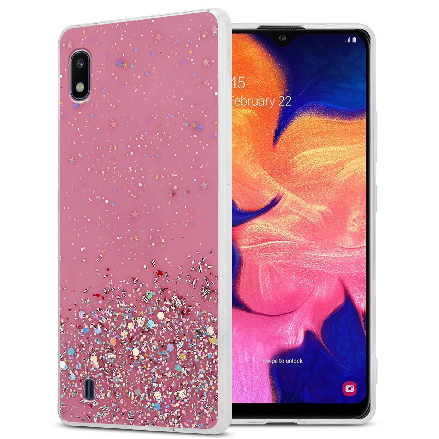 Eine rosa Handyhülle mit Glitzer und ein Telefon, das die Oberfläche anzeigt. Die Hülle links.
