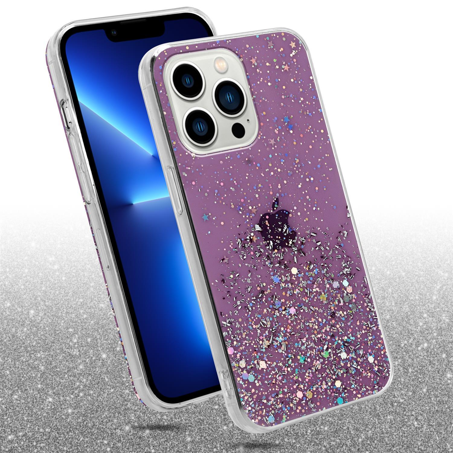 Eine lila Handyhülle mit Glitzer und Sternen auf einem Telefon, mit silbernem Glitzer-Hintergrund.