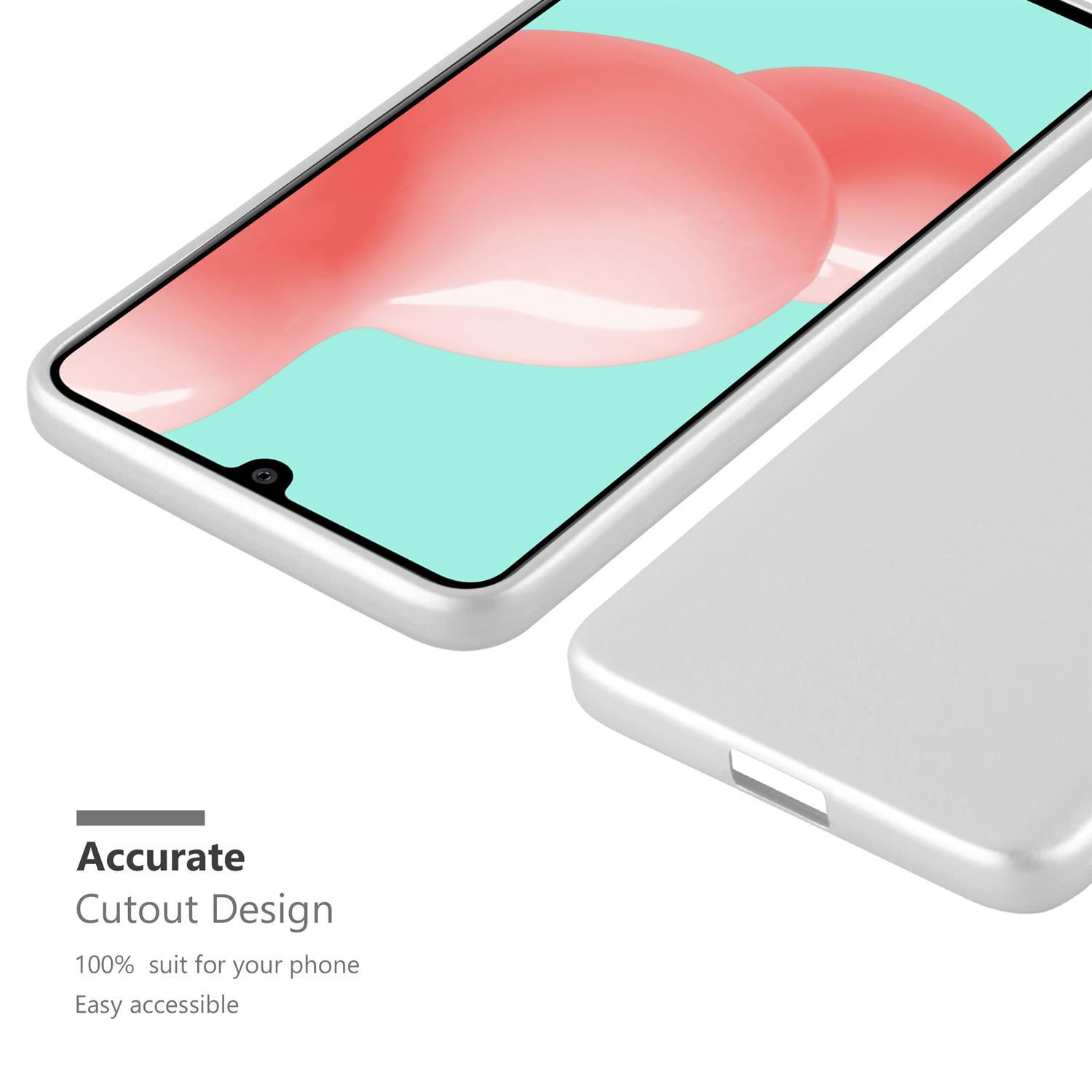 Nahaufnahme von Telefon und Hülle. Hülle ist grau, Telefon zeigt farbenfrohes Design.