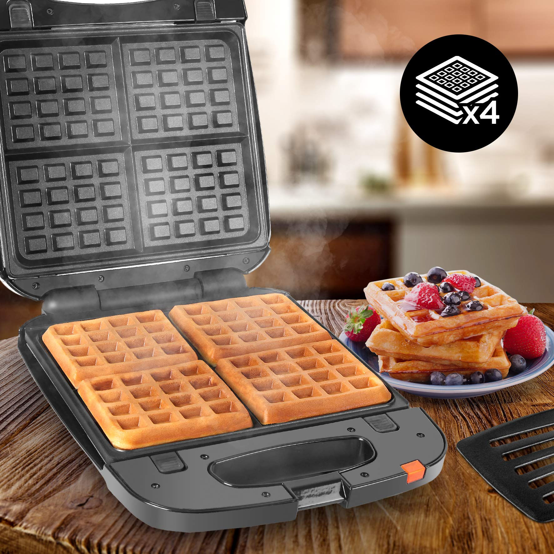 Waffeleisen mit zwei backenden Waffeln. Stapel Waffeln mit Früchten im Hintergrund. Schwarze Farbe.