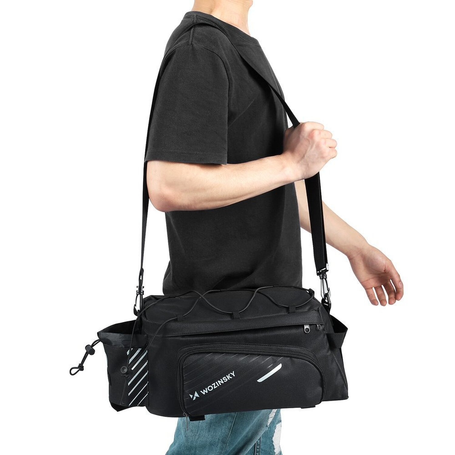 Eine Person, die eine schwarze Umhängetasche mit mehreren Taschen und einem weißen Logo trägt.