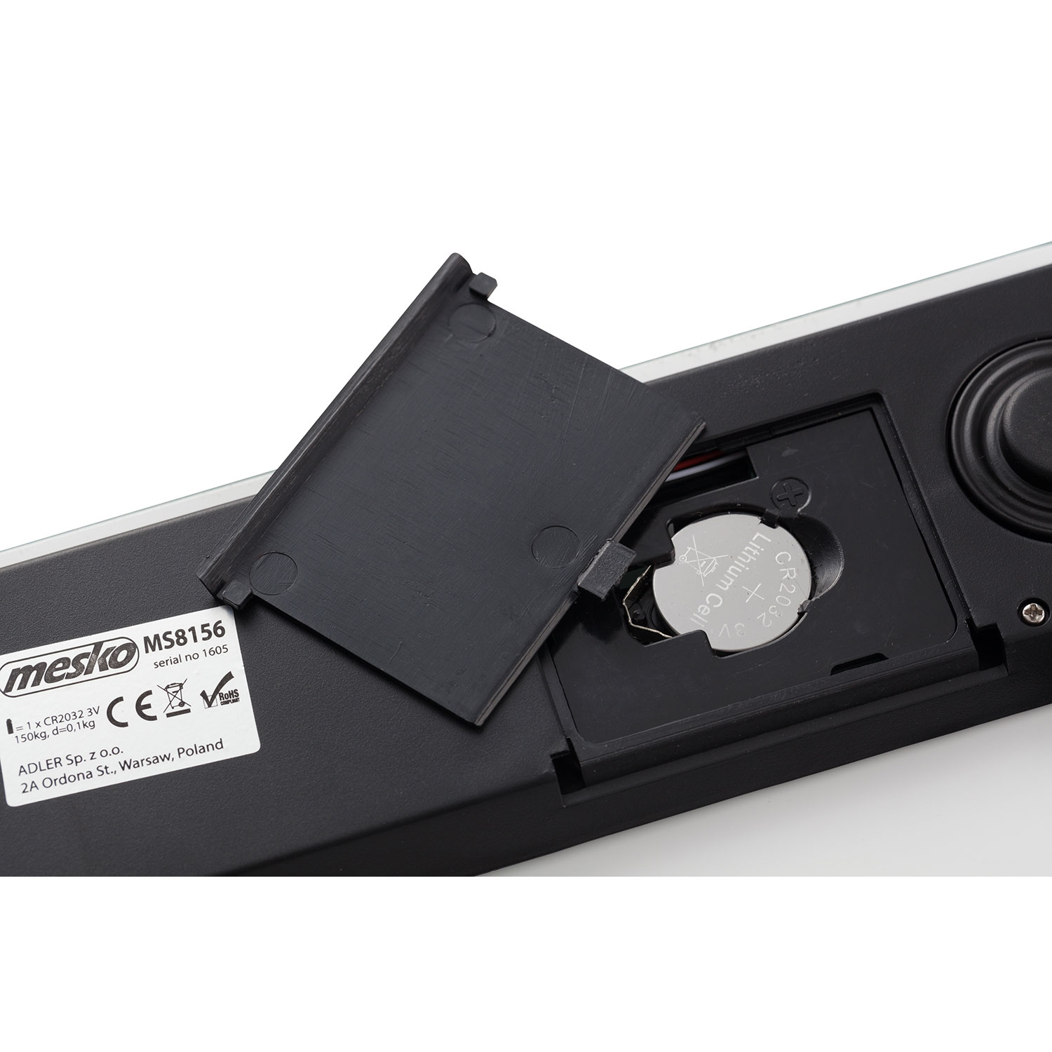 Primo piano del vano batteria di una bilancia. Il vano è aperto, rivelando una batteria all'interno.
