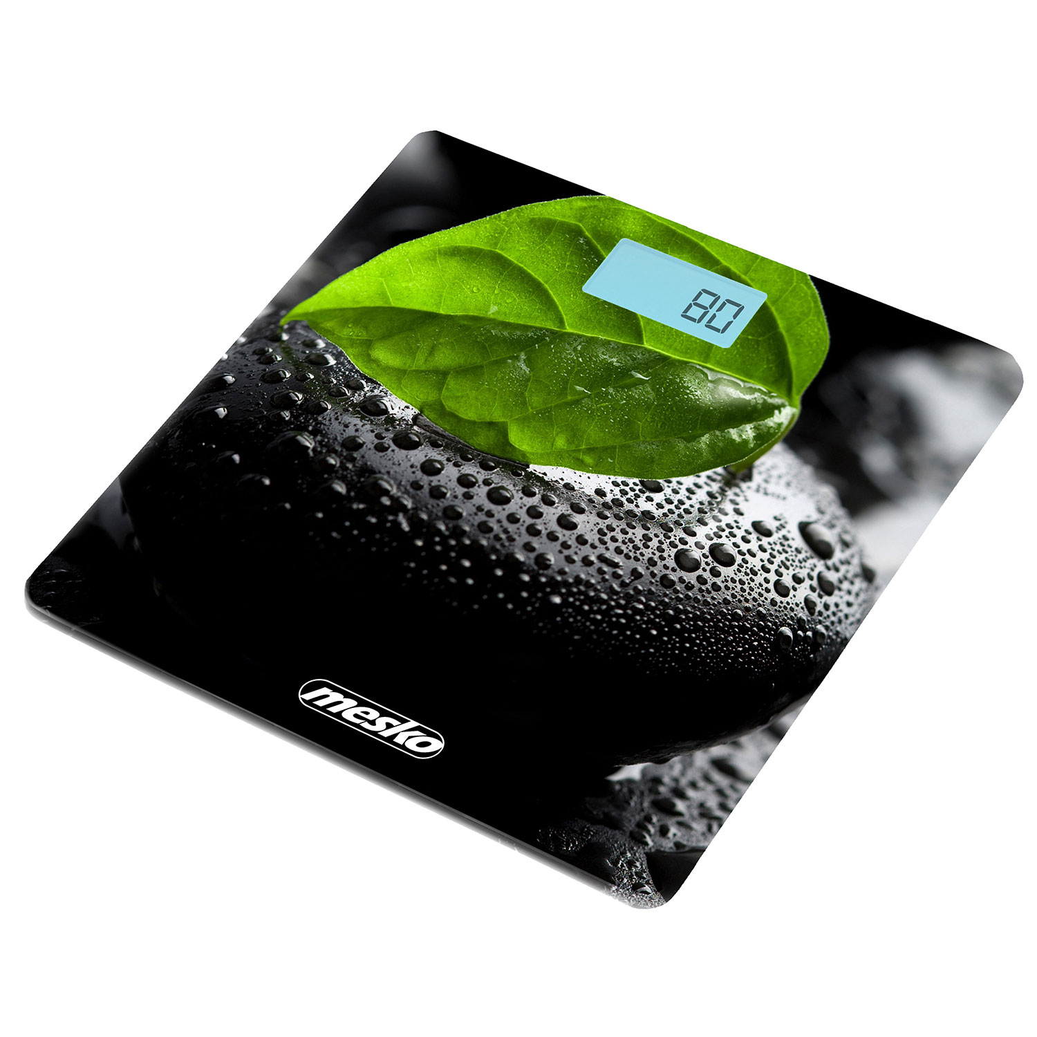 Eine digitale Waage mit einem grünen Blatt liegt auf einer schwarzen Steinfläche.