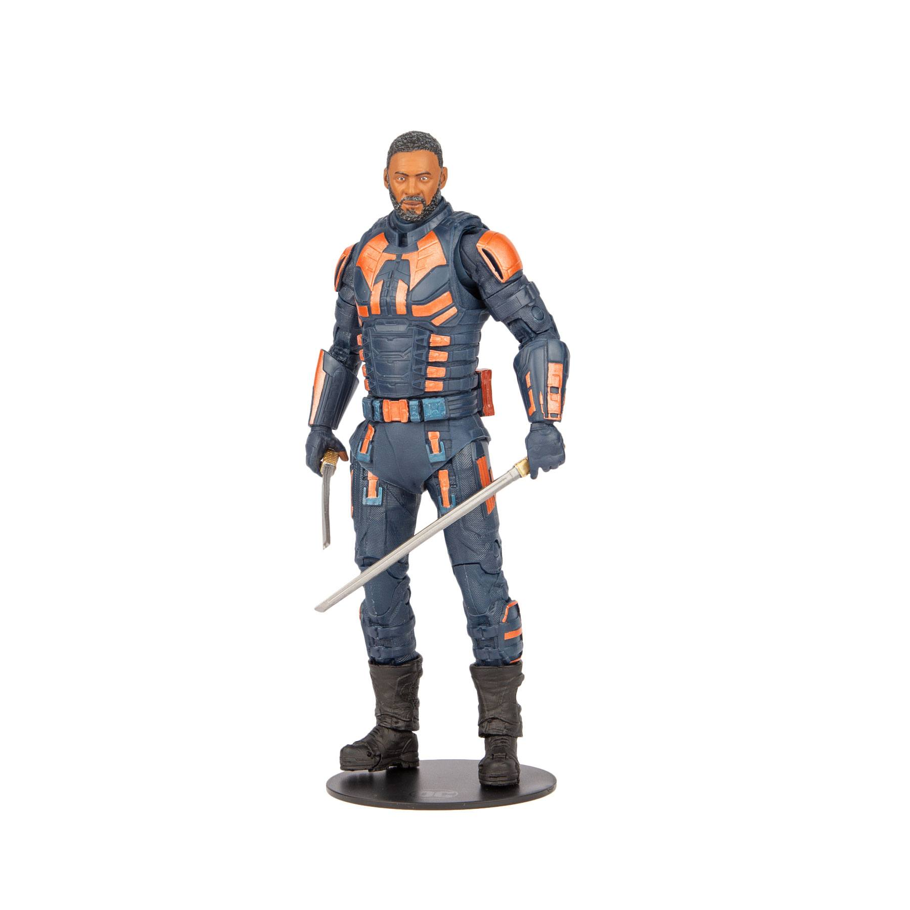 Actionfigur eines Mannes in blauer und oranger taktischer Ausrüstung, der Schwerter hält.