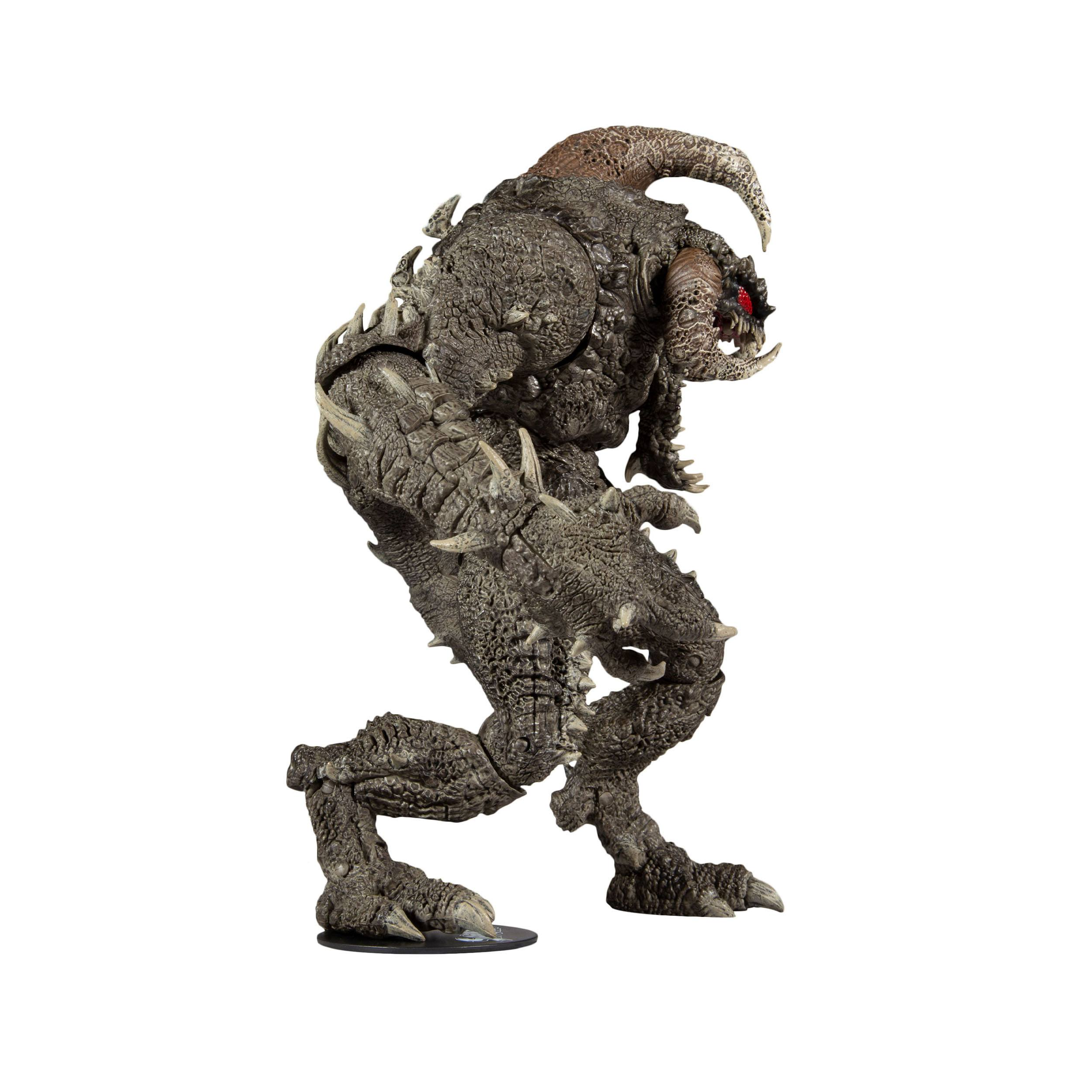 Eine Monster-Actionfigur, grau mit Stacheln, auf weißem Hintergrund, in einer Laufpose.