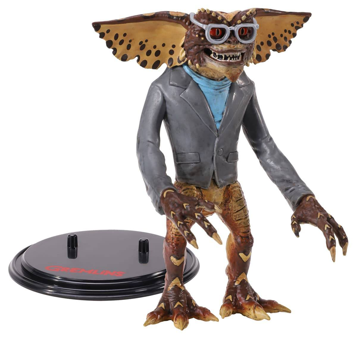 Gremlin-Figur mit Brille, Anzug und blauem Hemd. Es steht auf einem schwarzen Ständer.