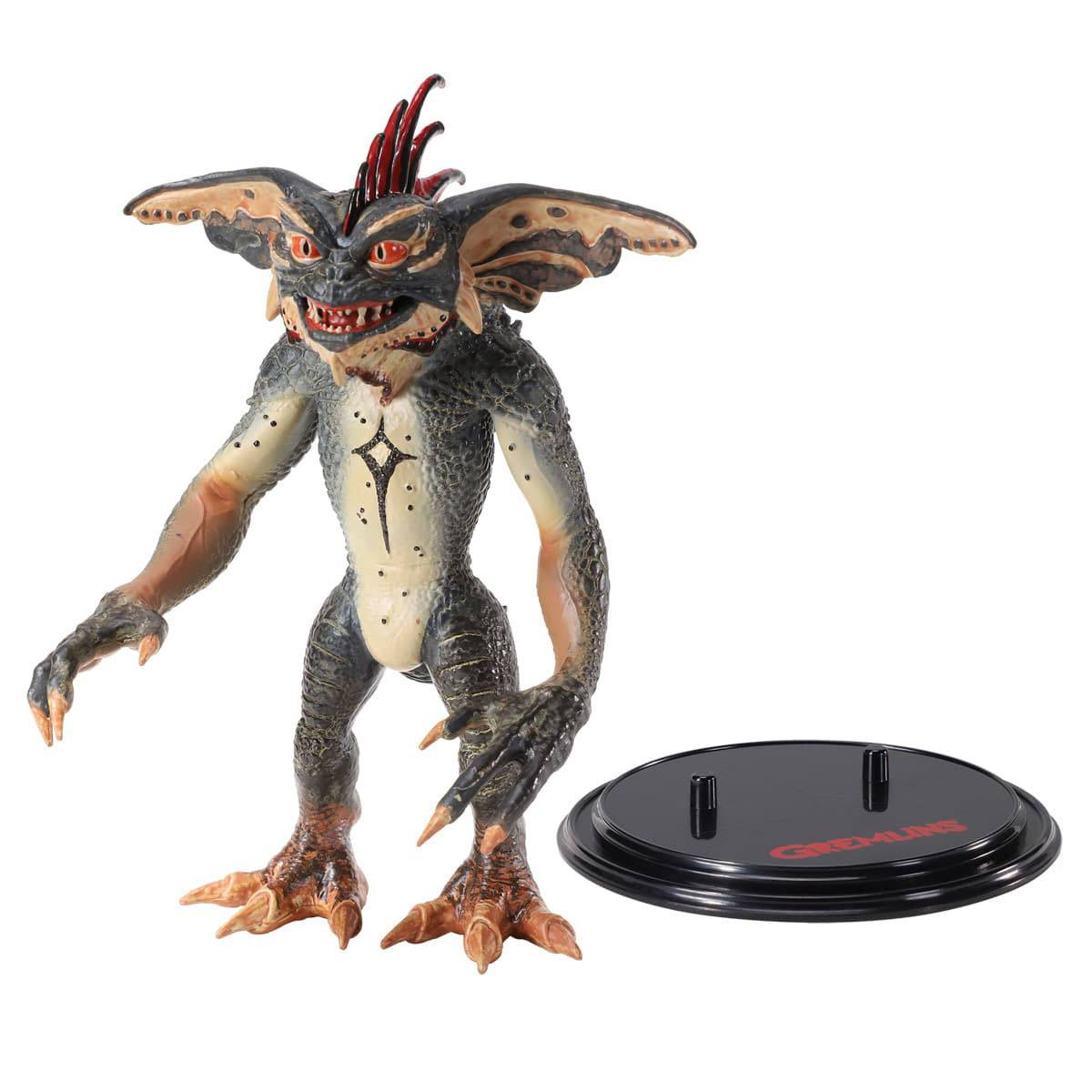 Gremlin-Figur auf schwarzem Ständer. Der Gremlin ist grau, hat rote Haare und ein breites Grinsen.
