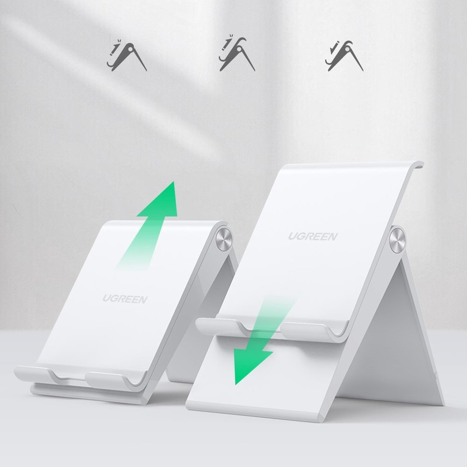 Zwei weiße Telefonständer mit UGREEN-Logo. Einer gefaltet, der andere mit grünem Pfeil zeigt das Öffnen.