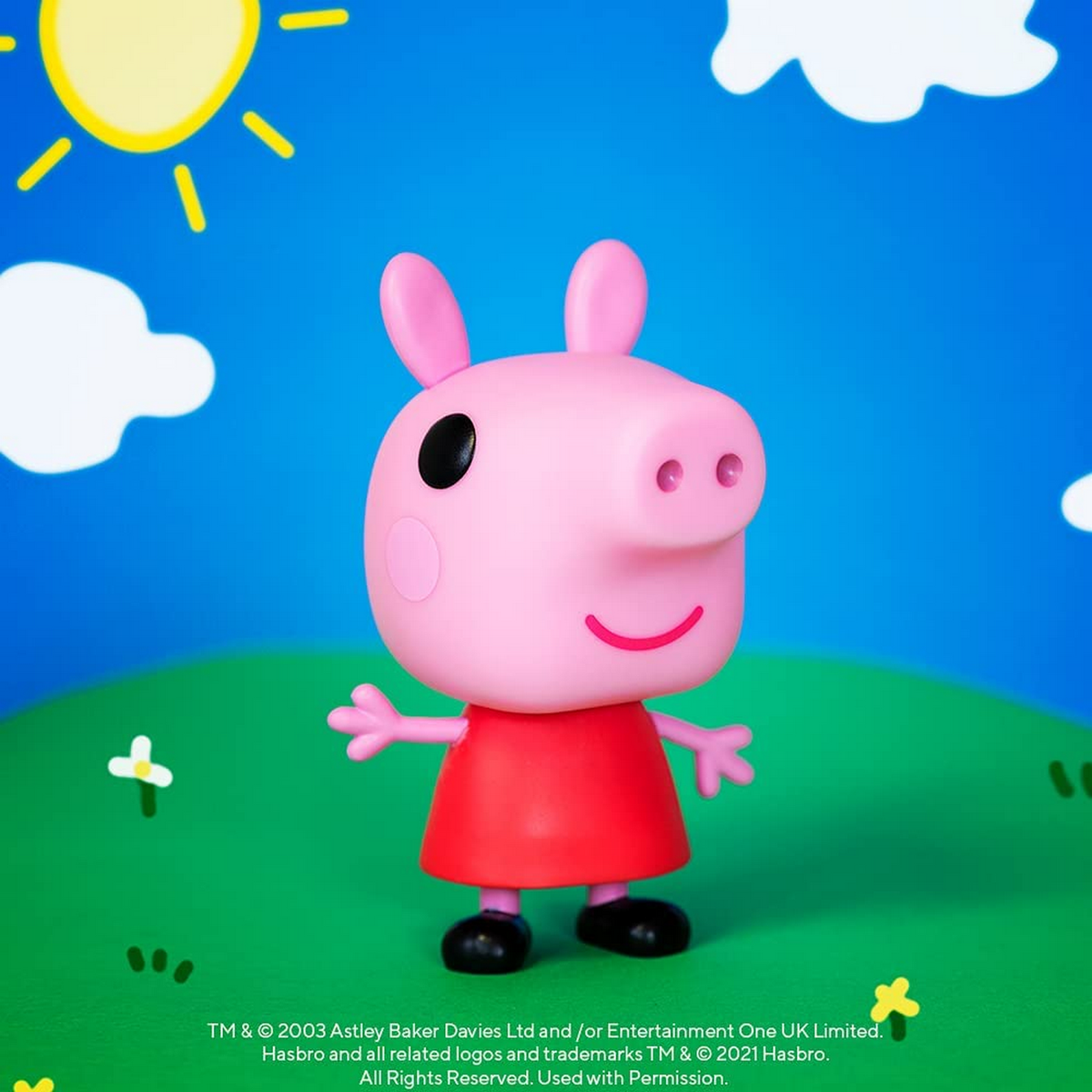 Juguete de Peppa Pig frente a un fondo de cielo azul y nubes blancas.