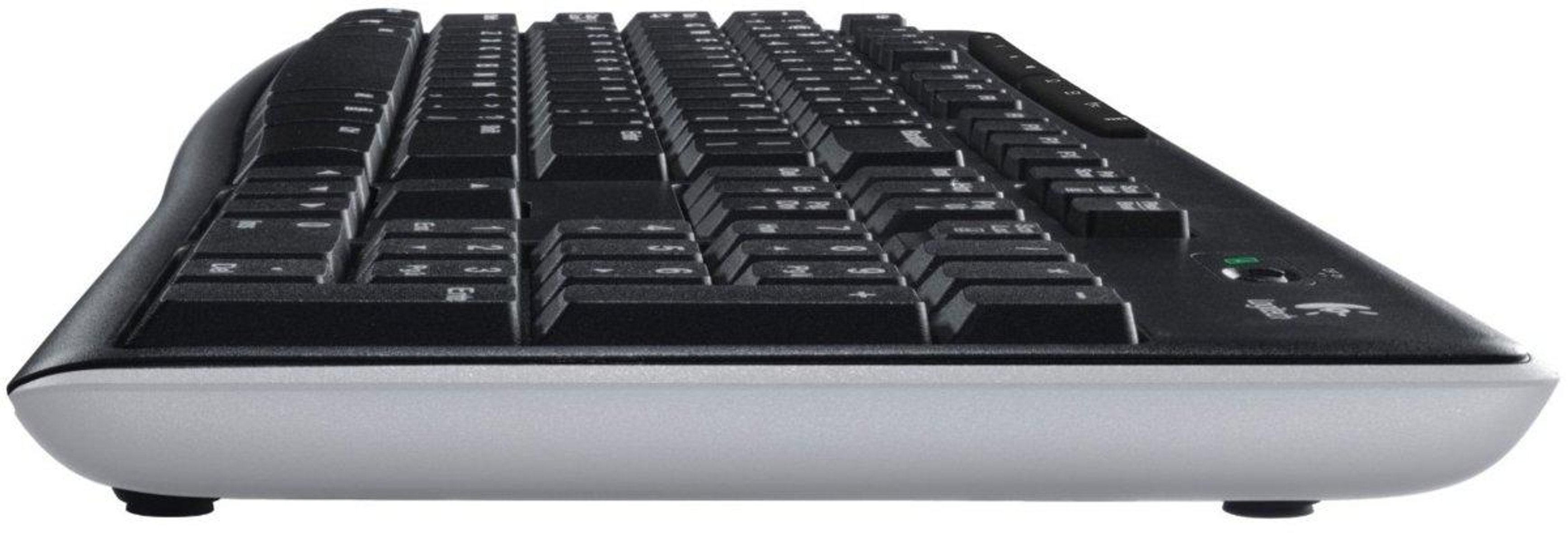 Czarna klawiatura z boku. Ma czarne klawisze i szarą podstawę. Klawiatura jest na białej powierzchni.