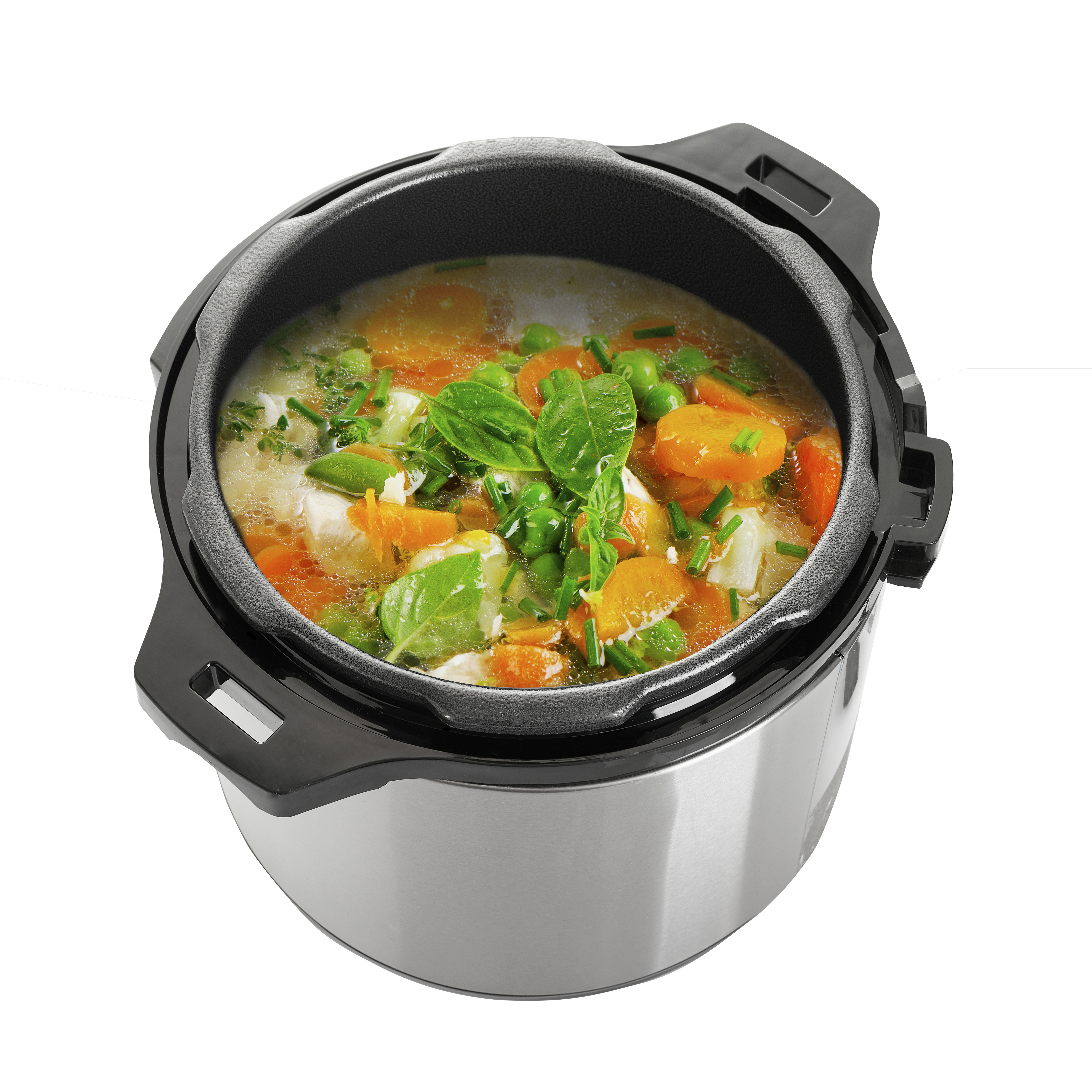 Una vista cenital de una olla a presión llena de verduras cocidas en caldo. La olla está sobre una superficie blanca.