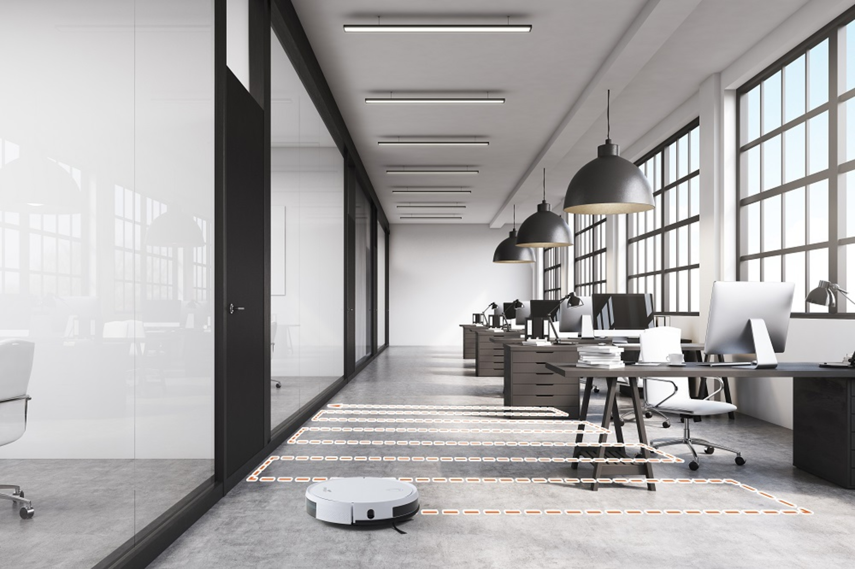 Moderner Büroraum mit einem Roboter-Staubsauger, der putzt. Schreibtische, Stühle und Fenster sind sichtbar. Linien zeigen den Reinigungspfad an.