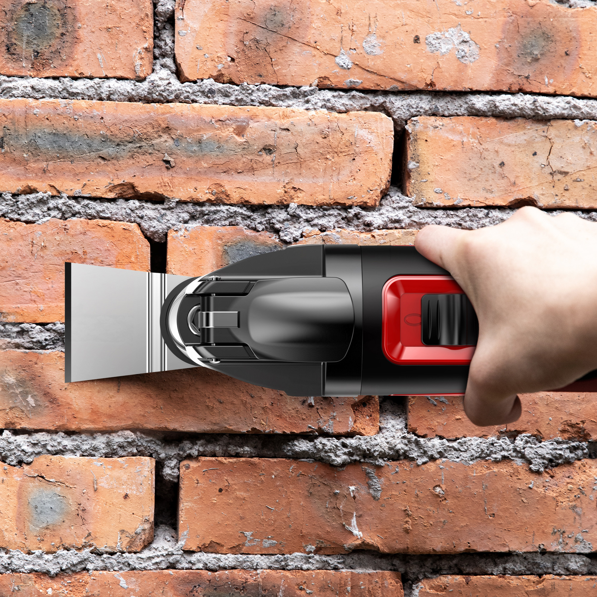 Hand benutzt ein schwarz-rotes Werkzeug an einer roten Backsteinmauer.