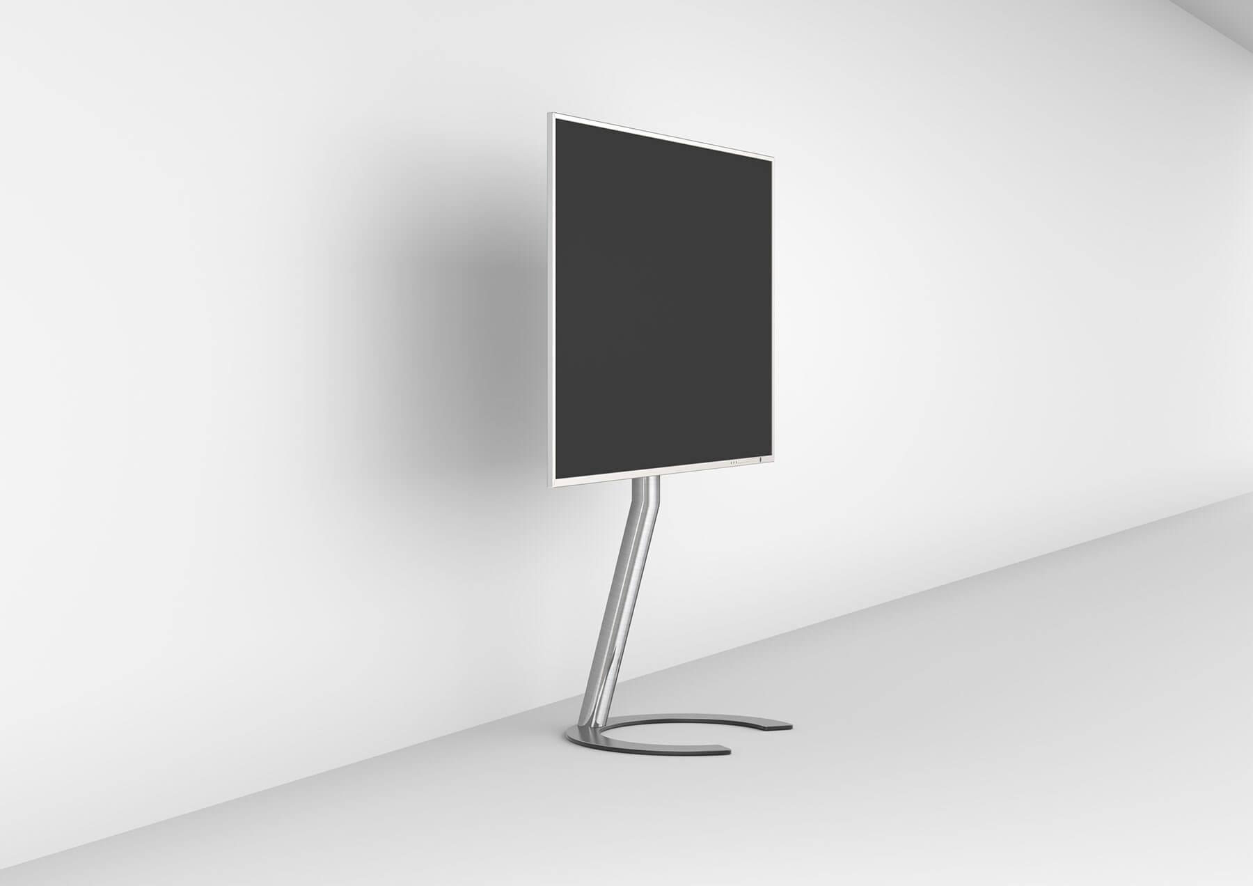 Ein moderner, minimalistischer Standfuß mit schwarzem Bildschirm vor weißer Wand.