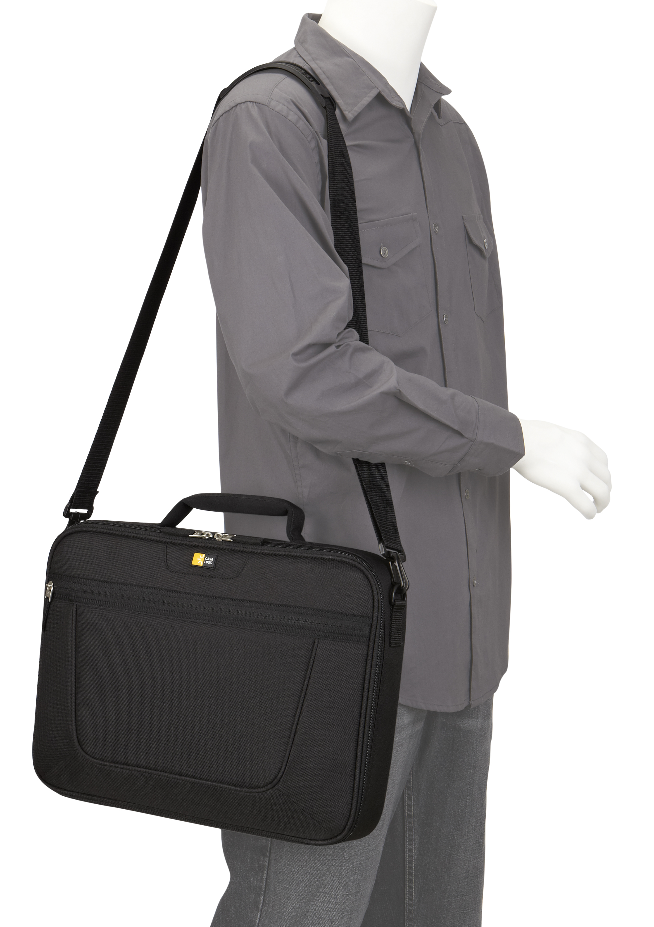 A person with a gray shirt and black bag on their shoulder. The bag is black with a handle.
