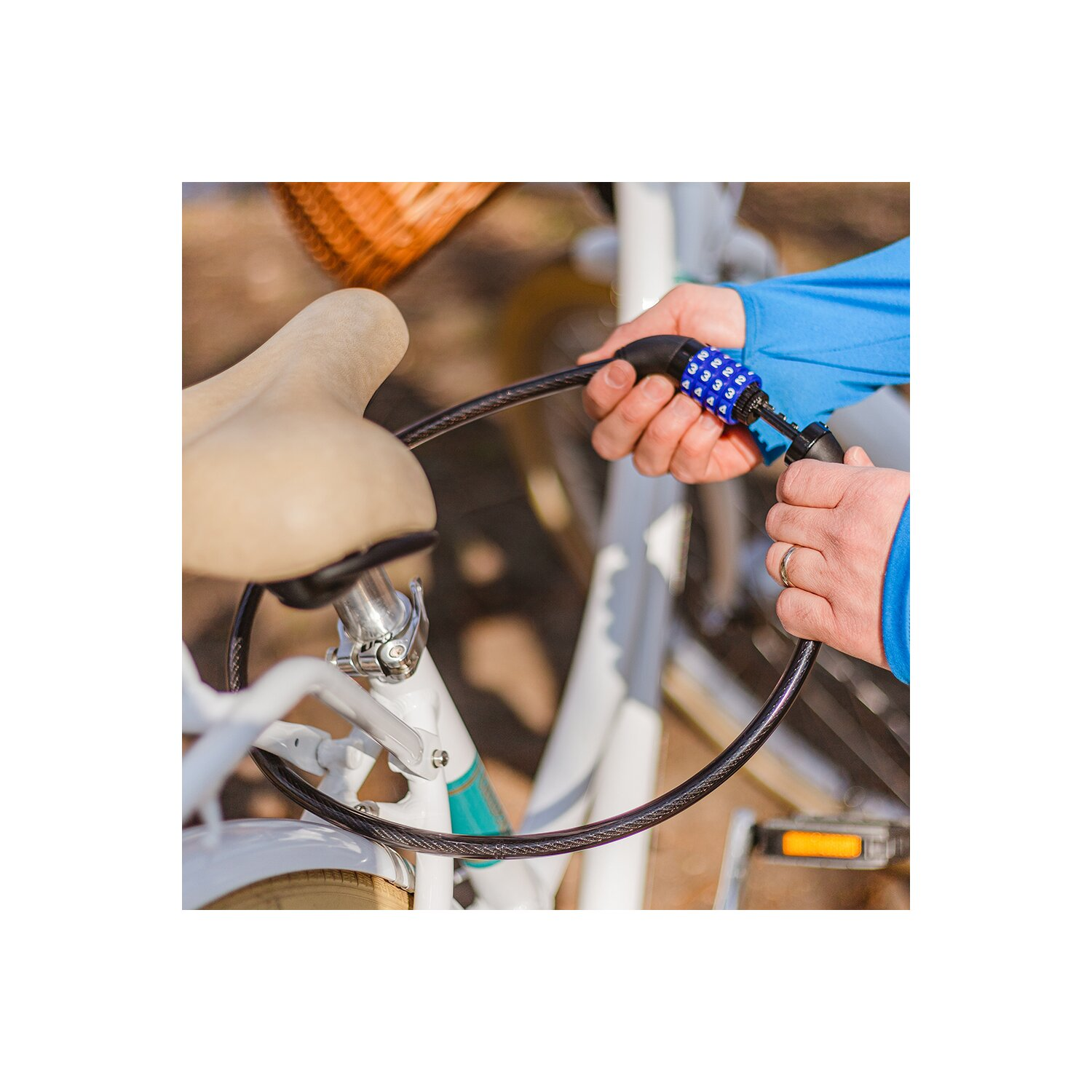 Eine Person, die ein Fahrrad mit einem Zahlenschloss abschließt.