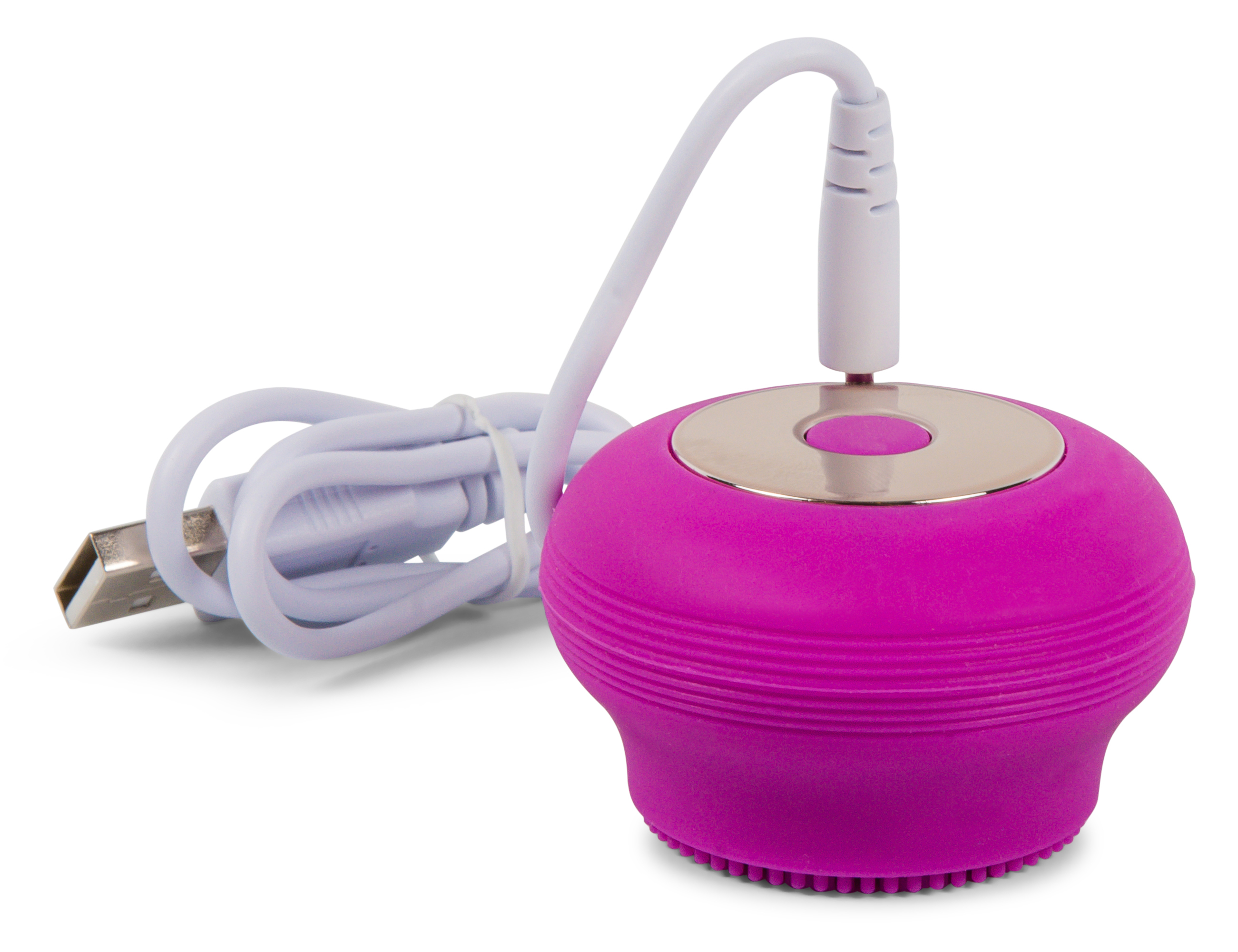 Ein rosa, rundes Gesichtsreinigungsgerät mit weißem USB-Ladekabel, vor weißem Hintergrund.