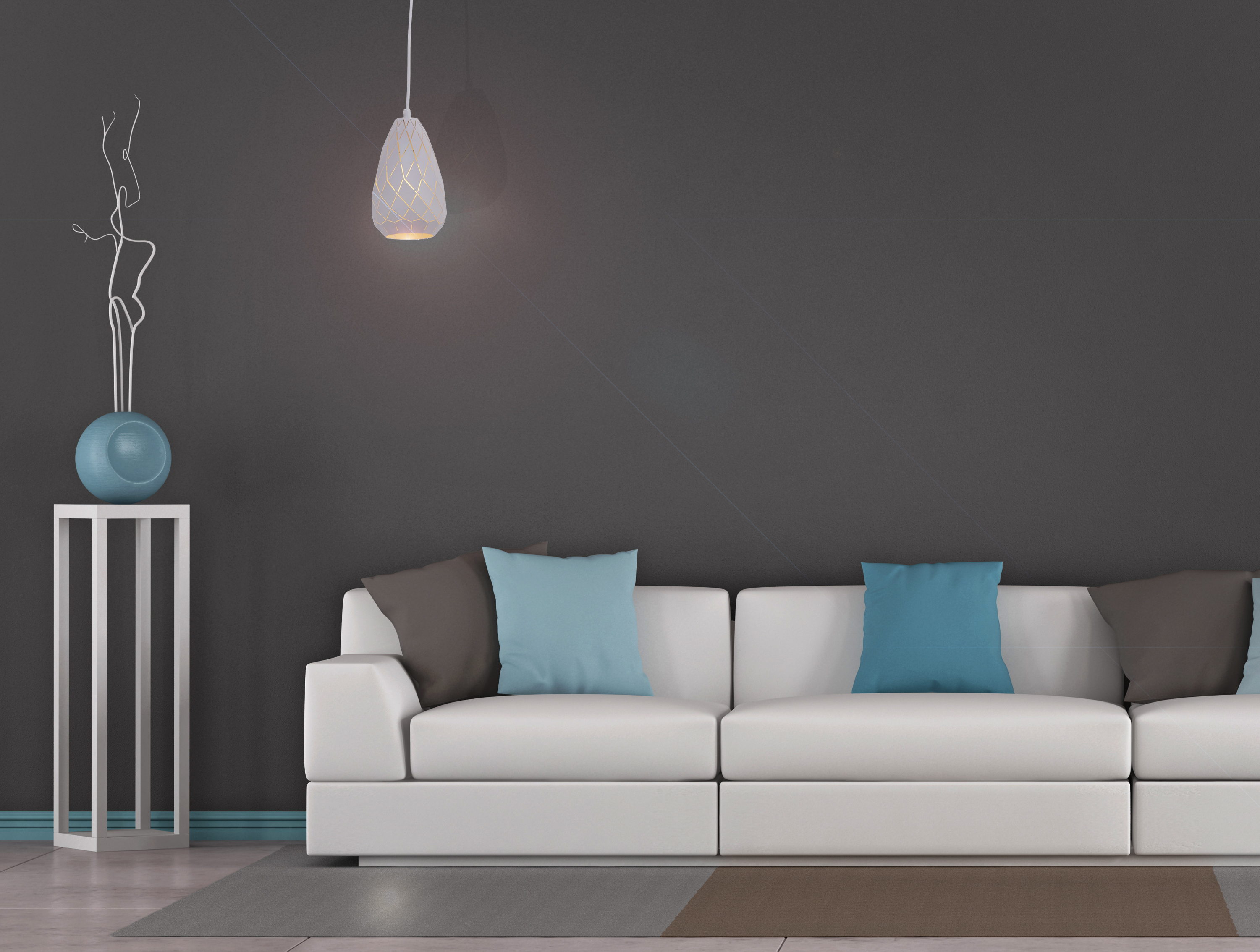 Ein weißes Sofa mit blauen Kissen, eine Pflanze und eine Hängelampe.