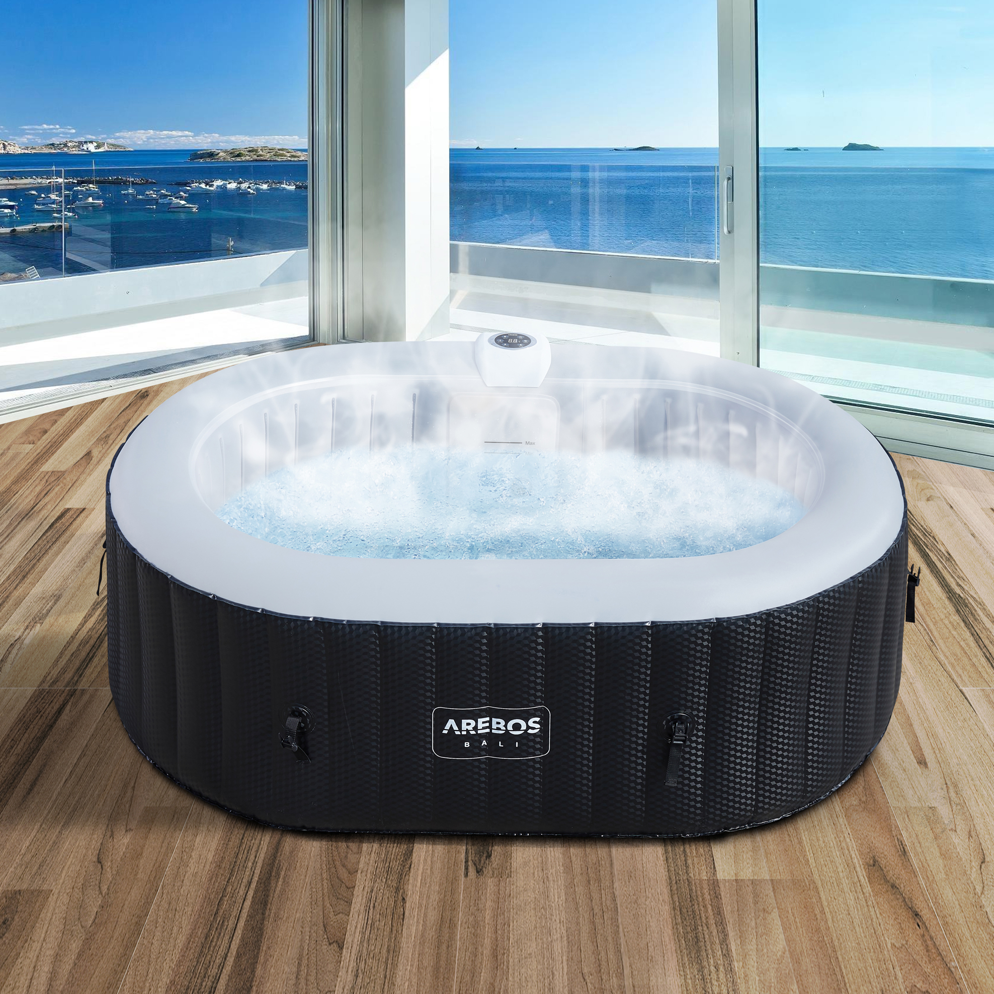 Outdoor-Whirlpool mit sprudelndem Wasser, Schwarz-Weiß-Design, an großen Fenstern mit Meerblick.