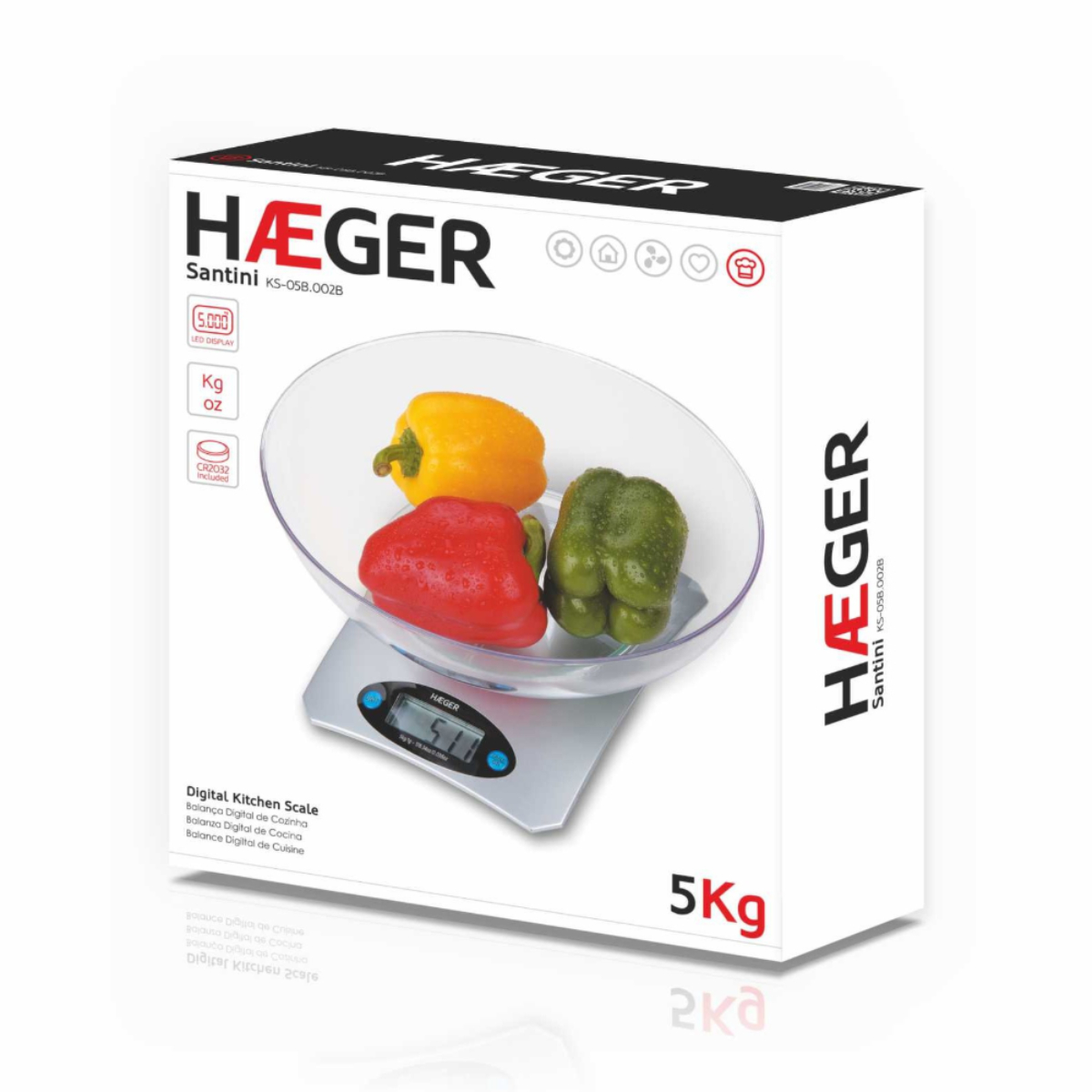 Cyfrowa waga kuchenna z miską zawierającą trzy papryki.