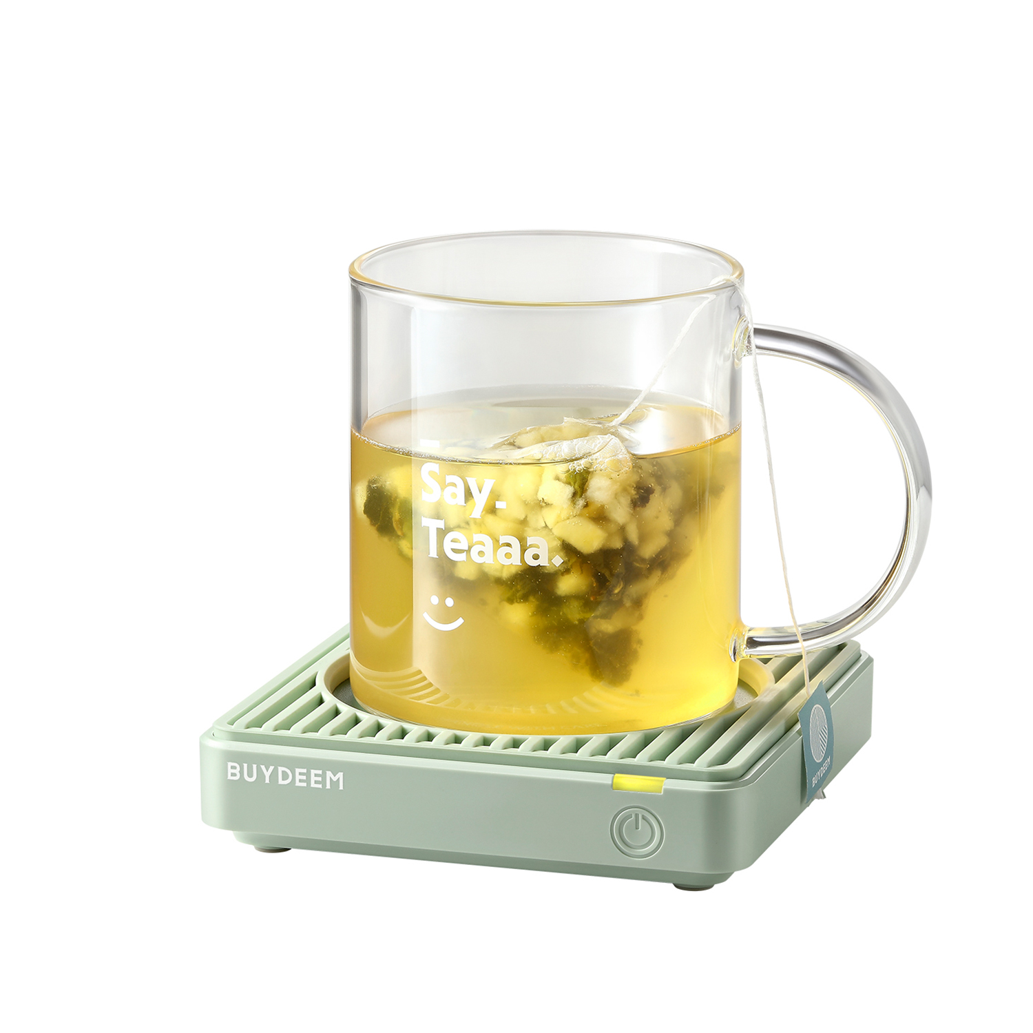 Szklany kubek z torebką herbaty na miętowym podgrzewaczu z napisem 'Say. Tea'.
