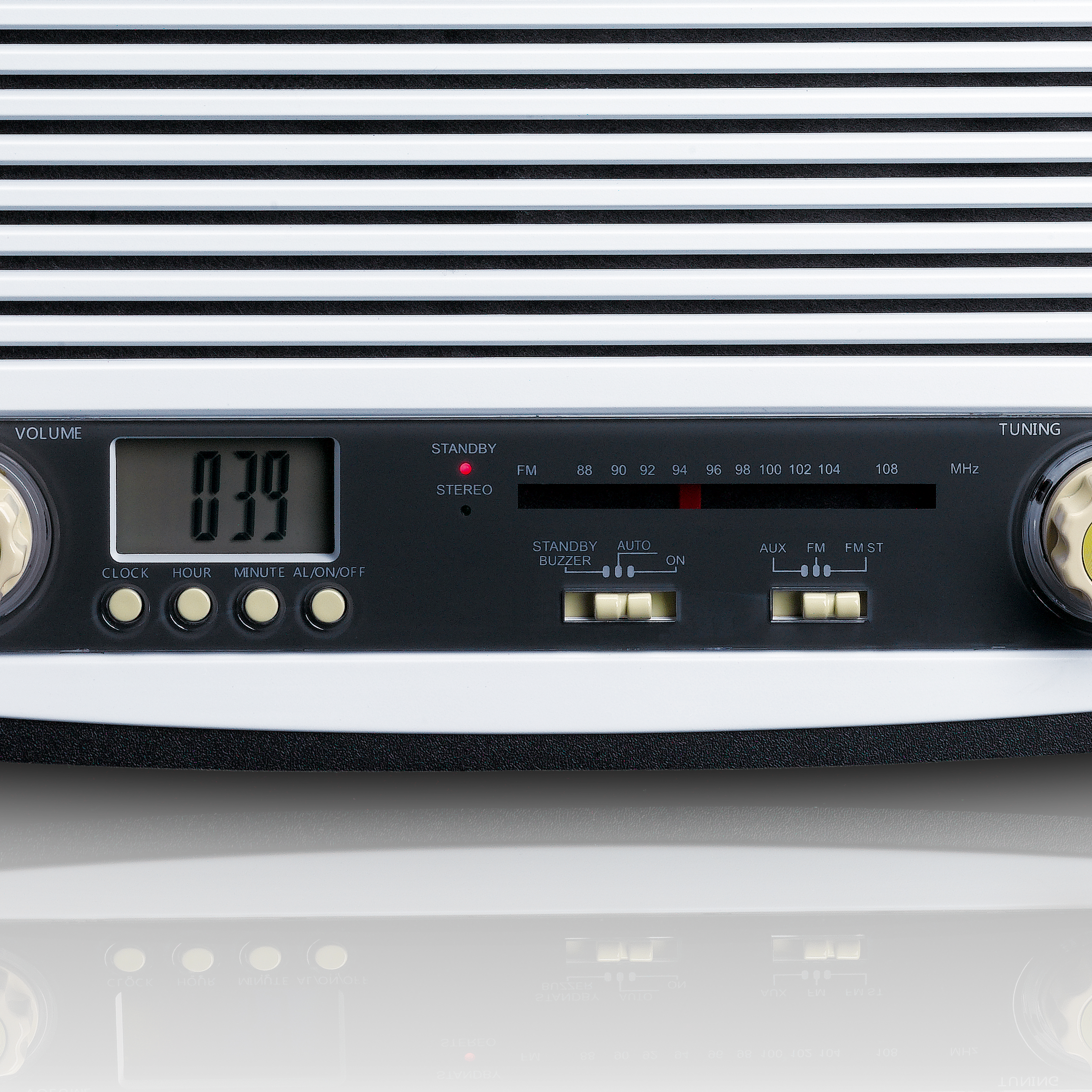 Radio with a digital display and buttons, reflective surface below.