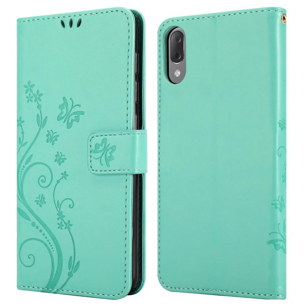Una custodia per telefono verde menta con un design floreale. La custodia è aperta, che mostra l'interno.