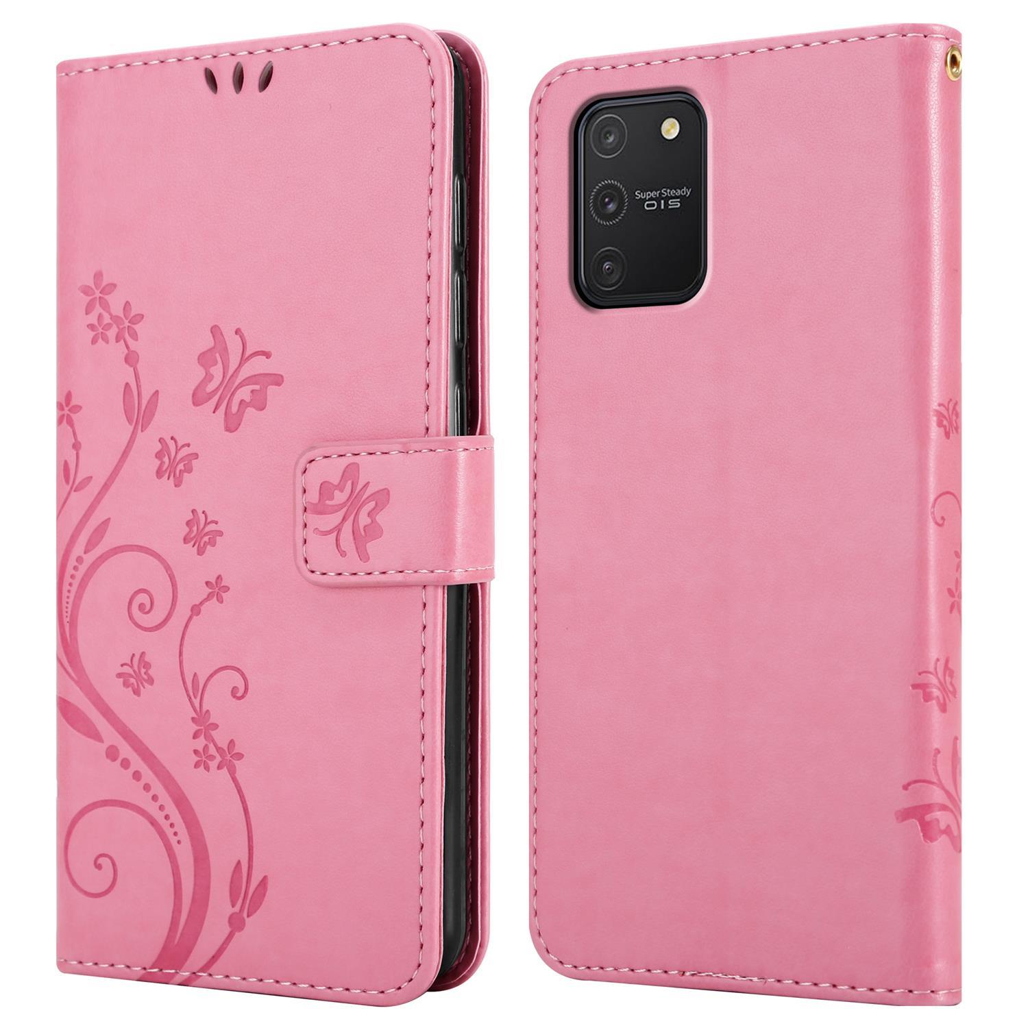 Una custodia per telefono rosa, chiusa e aperta. La custodia chiusa ha un design a farfalla. La custodia aperta mostra il telefono.