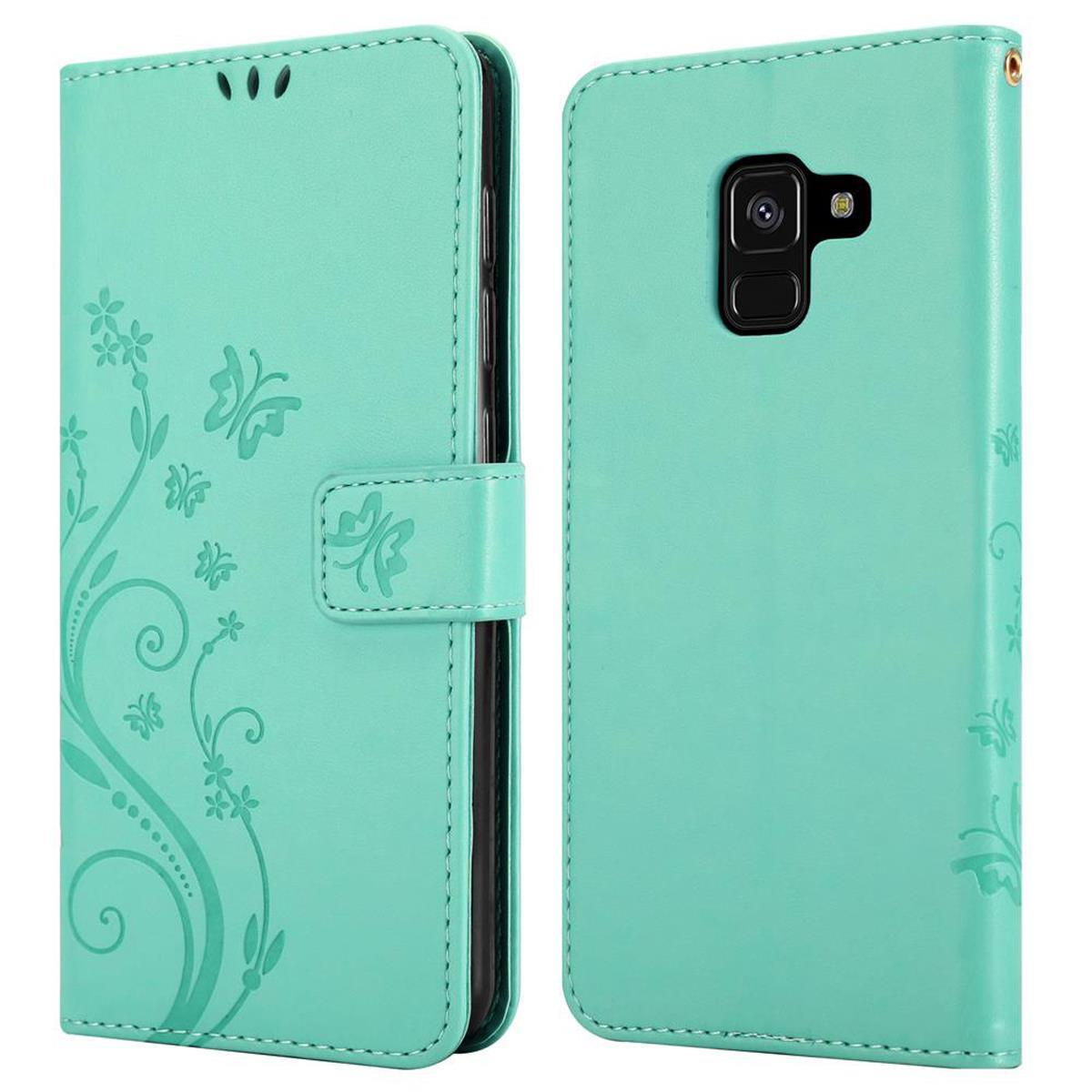 Custodia per telefono verde chiaro con disegni floreali e chiusura magnetica.