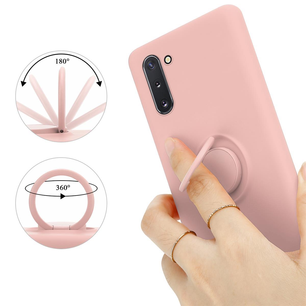 Telefono rosa con anello di supporto. L'anello ruota di 180 e 360 gradi, tenuto da una mano.