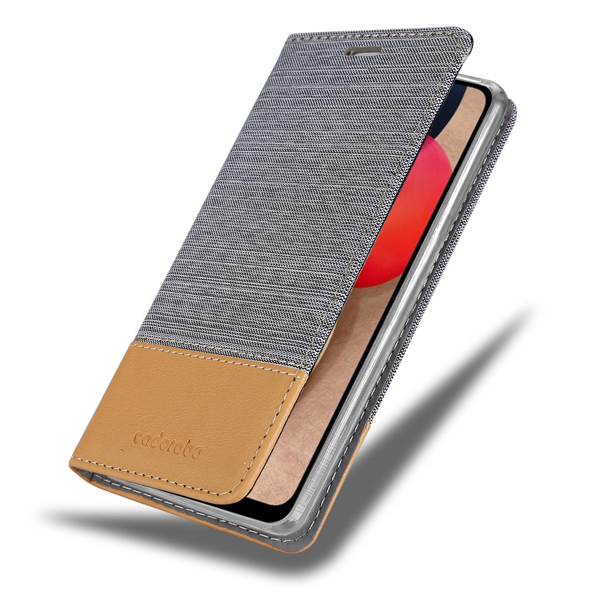 Geöffnete Handyhülle, Telefon sichtbar. Graue und braune Hülle, teilweise offener Deckel. Das Telefon ist sichtbar.