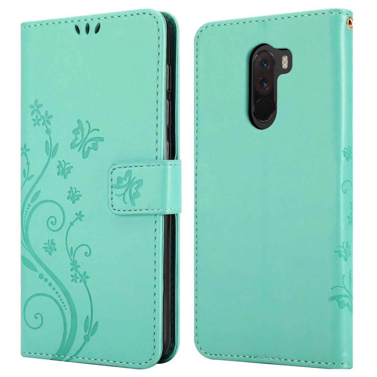 Una custodia per telefono turchese con un design floreale.
